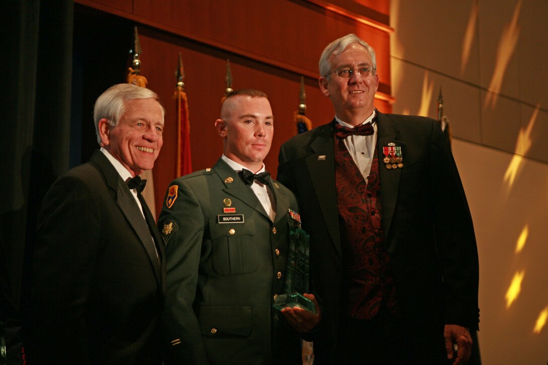Spc. Nathaniel J. Southern, 105th Military Police Battalion, North Carolina Army National Guard, receives an award during a banquet celebrating the USO of North Carolina's 70 anniversary at the Raleigh Convention Center, Raleigh, N.C., Oct. 7. Southern received the award for cutting and removing a 40-foot power pole that had crushed and trapped his co-worker.