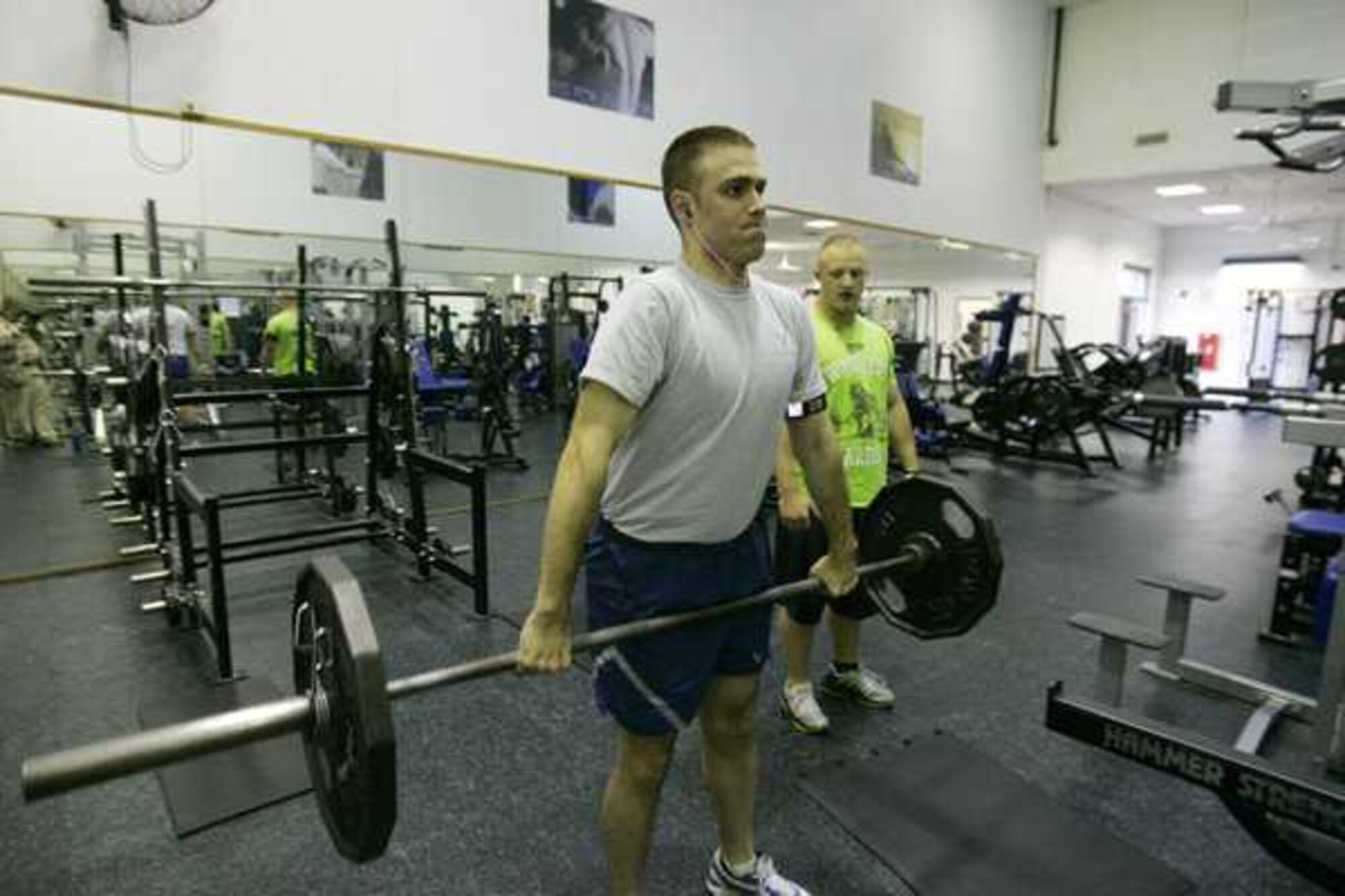 Staff Sgt. Trevor Taylor , right, spots for Senior Airman Bradley Nendel in the gym September 30, 2011 on Joint Base Lewis-McChord, Wash. (Courtesy photo/David Poe)