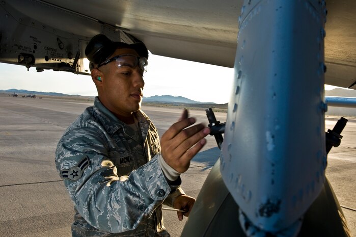 U.S. Air Force Airman 1st Class Isiah McNeil, 757th Aircraft Maintenance Squadron aircraft armament systems apprentice, locks a Mk-82 general purpose bomb down to an A-10 Thunderbolt II during a load crew competition Oct. 7, 2011, at Nellis Air Force Base, Nev. Weapons load competitions are conducted quarterly to keep Airmen sharp and recognize superior performers. Weapons load teams are evaluated for use of the checklist, safety, and overall speed. (U.S Air Force photo by Airman 1st Class Daniel Hughes/Released)