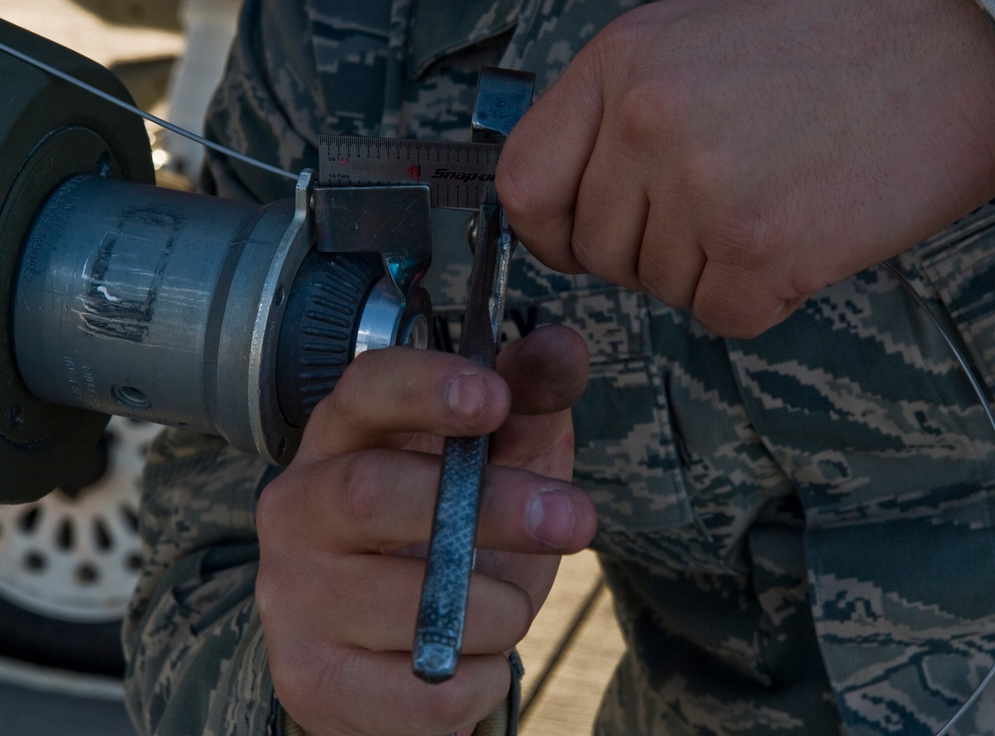 U.S. Sir Force Senior Airman Jonathan Tilley, 57th Aircraft Maintenance Squadron aircraft armament systems journeyman, clips excess guide wire on a Mk-82 general purpose bomb during a load crew competition Oct. 7, 2011, at Nellis Air Force Base, Nev. Weapons load competitions are conducted quarterly to keep Airmen sharp and recognize superior performers. Weapons load teams are evaluated for use of the checklist, safety, and overall speed. (U.S Air Force photo by Airman 1st Class Daniel Hughes/Released)