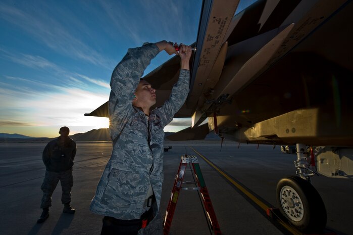 U.S. Air Force Senior Airman Phillip Hohner,  757th Aircraft Maintenance Squadron aircraft armament systems journeyman, prepares a F-15 Eagle for the weapons load during a load crew competition Oct. 7, 2011, at Nellis Air Force Base, Nev. Weapons load competitions are conducted quarterly to keep Airmen sharp and recognize superior performers. Weapons load teams are evaluated for use of the checklist, safety, and overall speed. (U.S Air Force photo by Airman 1st Class Daniel Hughes/Released)