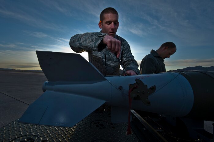 U.S. Air Force Airman 1st Class Ryan Mills, Staff Sgt. Kyle Britton, 757th Aircraft Maintenance Squadron aircraft armament systems airman inspects a Mk-82 general purpose bomb during a load crew competition Oct. 7, 2011, at Nellis Air Force Base, Nev. Weapons load competitions are conducted quarterly to keep Airmen sharp and recognize superior performers. Weapons load teams are evaluated for use of the checklist, safety, and overall speed. ( U.S Air Force photo by Airman 1st Class Daniel Hughes/Released)