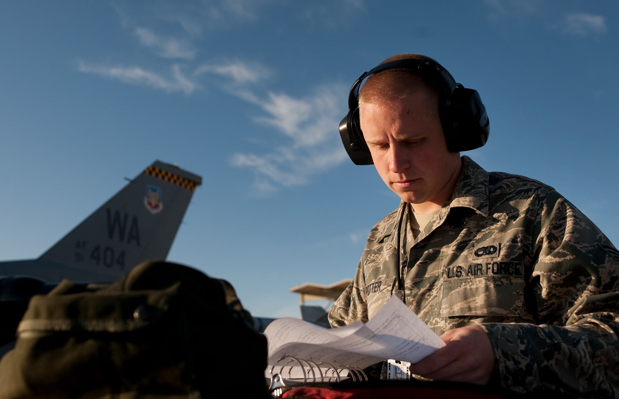 U.S. Air Force Senior Airman Jessee Potter, 57th Aircraft Maintenance Squadron aircraft armament systems journeyman, reviews a checklist for an F-16 Fighting Falcon during the quarterly weapons load competition Oct. 7, 2011, at Nellis Air Force Base, Nev. Weapons load competitions are conducted quarterly to keep Airmen sharp and recognize superior performers. Weapons load teams are evaluated for use of the checklist, safety, and overall speed. (U.S. Air Force photo by Staff Sgt. Christopher Hubenthal/Released)
