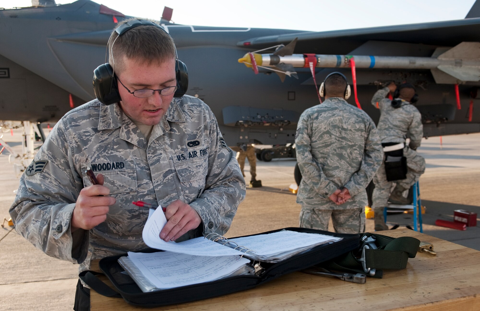 U.S. Air Force Senior Airman Tyler Woodard, 757th Aircraft Maintenance Squadron aircraft armament systems journeyman, reviews a checklist for an F-15 Eagle during the quarterly weapons load competition Oct. 7, 2011, at Nellis Air Force Base, Nev. Weapons load competitions are conducted quarterly to keep Airmen sharp and recognize superior performers. Weapons load teams are evaluated for use of the checklist, safety, and overall speed. (U.S. Air Force photo by Staff Sgt. Christopher Hubenthal/Released)

