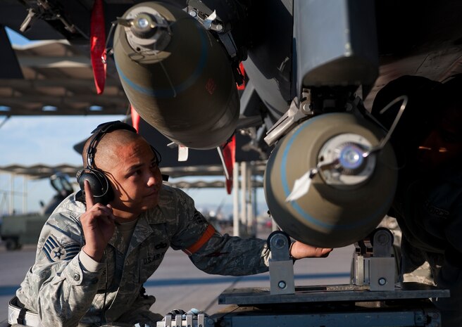 U.S. Air Force Staff Sgt. Ryan Reyes, 757th Aircraft Maintenance Squadron aircraft armament systems journeyman, ensures Mk-82 general purpose bomb's are properly loaded on an F-15 Eagle during the quarterly weapons load competition Oct. 7, 2011, at Nellis Air Force Base, Nev. Weapons load competitions are conducted quarterly to keep Airmen sharp and recognize superior performers. Weapons load teams are evaluated for use of the checklist, safety, and overall speed. (U.S. Air Force photo by Staff Sgt. Christopher Hubenthal/Released)