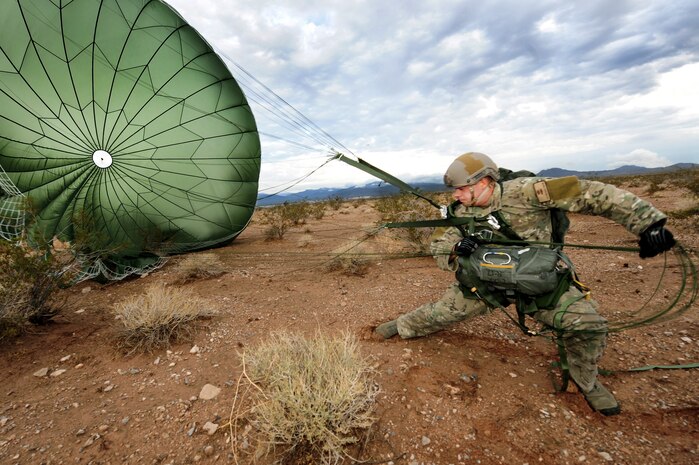 U.S. Air Force Staff Sgt. Brandon Pirmann, 820th Red Horse aircrew flight equipment craftsman, lands after a jump mission Oct. 4, 2011, at Nellis Air Force Base, Nev.  RED HORSE and 6th Combat Training Squadron Airmen perform airdrop missions to stay current on training and certifications, which enables them to perform jump missions and operate their own drop zones. (U.S. Air Force photo by Staff Sgt. William P. Coleman/Released)
  

