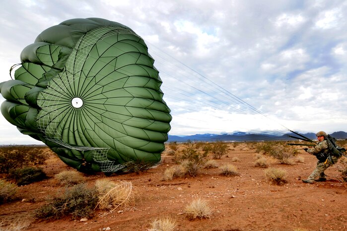 U.S. Air Force Staff Sgt. Brandon Pirmann, 820th Red Horse aircrew flight equipment craftsman, lands after a jump mission Oct. 4, 2011, at Nellis Air Force Base, Nev. The mission provided training and certification for RED HORSE Airmen, enabling them to perform jump missions and operate their own drop zones. (U.S. Air Force photo by Staff Sgt. William P.Coleman/Released)  