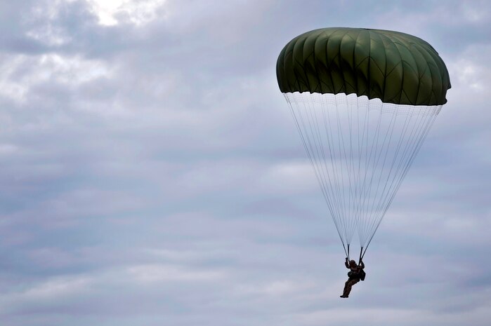 A U.S. Air Force Airman, 820th RED HORSE airborne flight, parachute into a drop zone from a C-130 Hercules during a training mission Oct. 4, 2011, at Nellis Air Force Base, Nev. RED HORSE and 6 CTS Airmen perform airdrop missions to stay current on training and certifications, enabling them to perform jump missions and operate their own drop zones. (U.S. Air Force photo by Senior Airman Brett Clashman/Released)