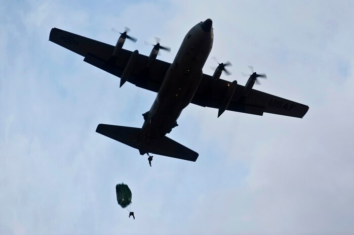 U.S. Air Force Airmen, 820th RED HORSE airborne flight, drop from a C-130 Hercules during a training mission Oct. 4, 2011, at Nellis Air Force Base, Nev. RED HORSE and 6 CTS Airmen perform airdrop missions to stay current on training and certifications, enabling them to perform jump missions and operate their own drop zones.  (U.S. Air Force photo by Senior Airman Brett Clashman/Released)
