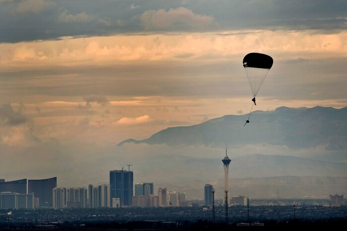 A U.S. Air Force Airman, 820th RED HORSE airborne flight, parachutes into a drop zone from a C-130 Hercules during a training mission Oct. 4, 2011, at Nellis Air Force Base, Nev. RED HORSE and 6th Combat Training Squadron Airmen perform airdrop missions to stay current on training and certifications, which enables them to perform jump missions and operate their own drop zones. (U.S. Air Force photo by Senior Airman Brett Clashman/Released)