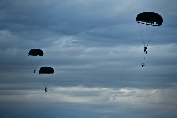 U.S. Air Force Airmen, 820th RED HORSE airborne flight, parachute into a drop zone from a C-130 Hercules Oct. 4, 2011, at Nellis Air Force Base, Nev. RED HORSE and 6 CTS Airmen perform airdrop missions to stay current on training and certifications, enabling them to perform jump missions and operate their own drop zones. (U.S. Air Force photo by Airman 1st Class Matthew Lancaster/Released)
