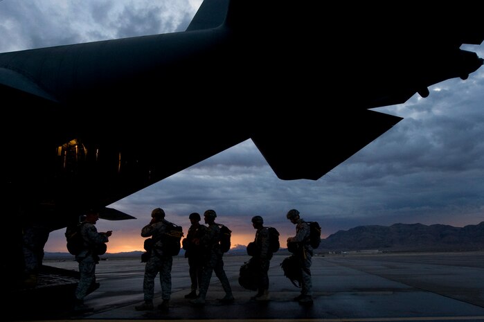 U.S. Air Force Airmen, 820th RED HORSE airborne flight and 6th Combat Training Squadron, board a C-130 Hercules during a training mission Oct. 4, 2011, at Nellis Air Force Base, Nev. RED HORSE and 6 CTS Airmen perform airdrop missions to stay current on training and certifications, which enables them to perform jump missions and operate their own drop zones. (U.S. Air Force photo by Staff Sgt. Christopher Hubenthal/Released)