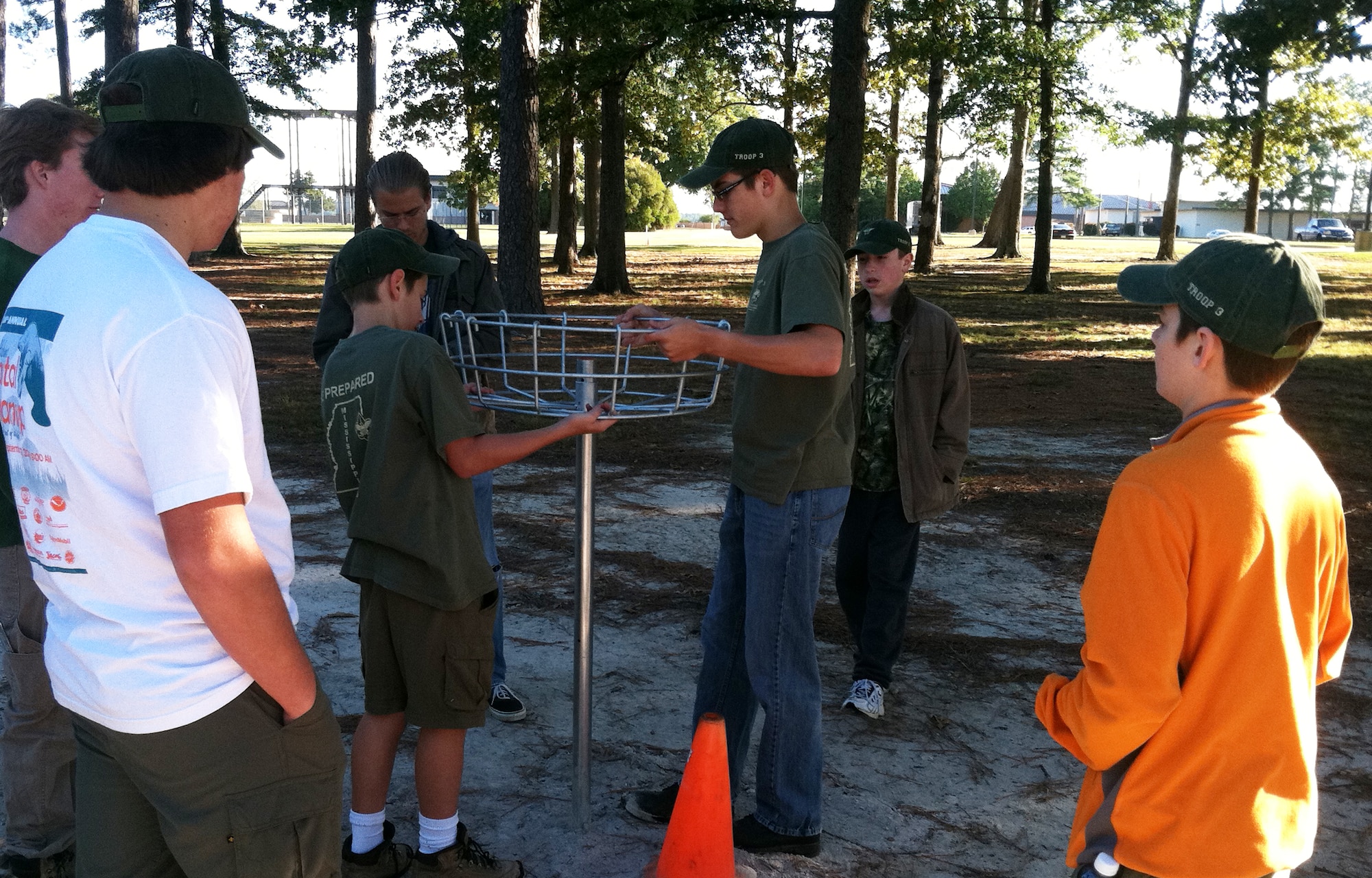 Alex Frickenstein demonstrates how to construct a basket for the disc golf course to volunteers from Boy Scouts of America Troop 3 on Oct. 1. BSA Troop 3 is one of the oldest troops in the nation. (U.S. Air Force photo/Col. Scott Frickenstein)