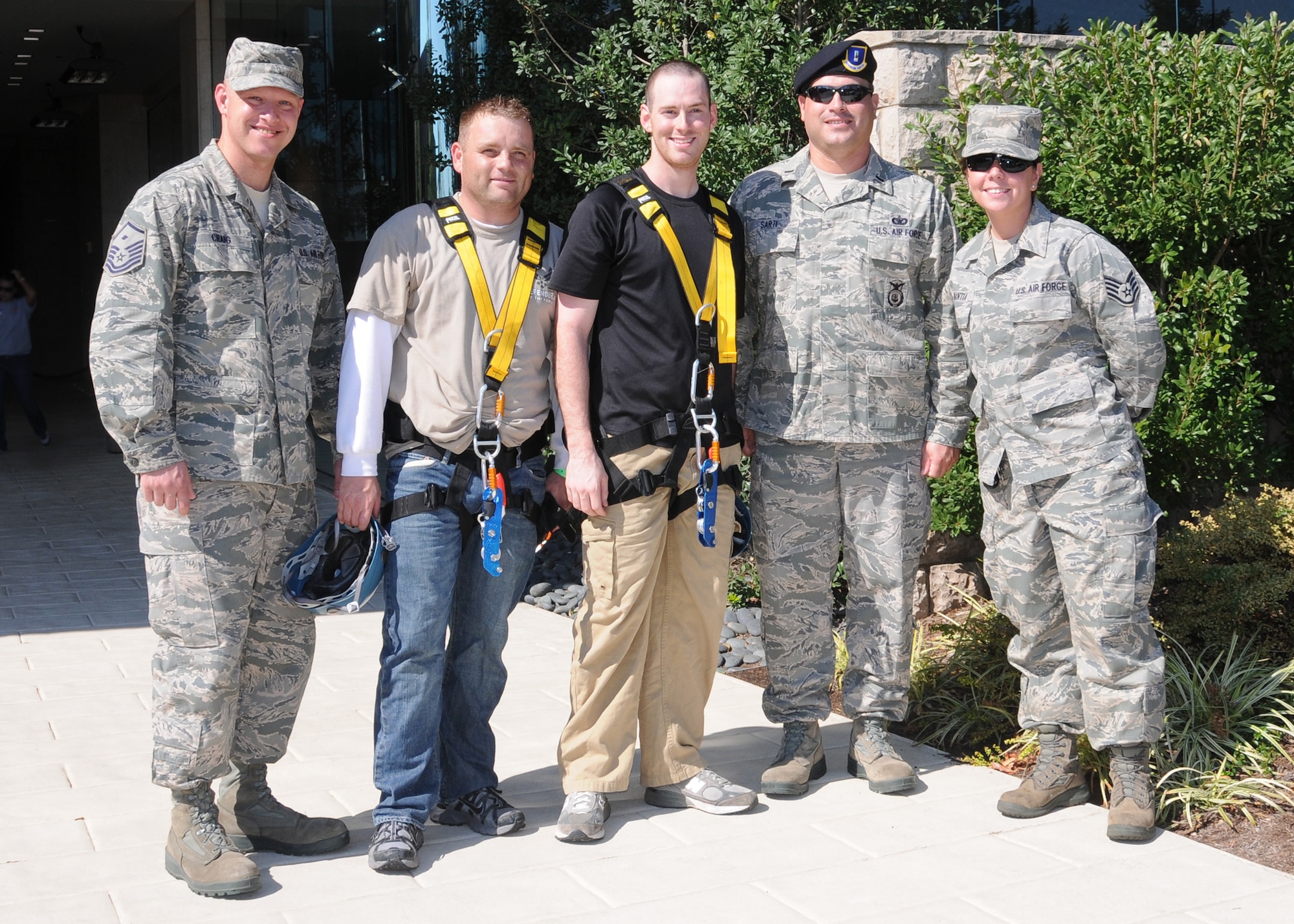 Staff Sgts. Tim Reynolds and Mike Lay stand proudly with their commander, 1st Lt. William Sarti, 131st Security Forces, after completing their 19 story rappel during the "Over the Edge" event sponsored by Special Olympics at the Four Seasons Hotel, Saint Louis, Oct 7. Both raised over $1000.00 in support of Special Olympics in the Saint Louis area.  Master Sgt. James Craig, 131st Security Forces, and Staff Sgt. Sarah Mantia, 131st Logistics Readiness Squadron also lent their support.  The Missouri Air and Army National Guard is an official sponsor of Special Olympics.  All pictured are members of the of the 131st Bomb Wing, Missouri Air National Guard, at
Lambert-Saint Louis,  (Photo by Master Sgt. Mary-Dale Amison).  
