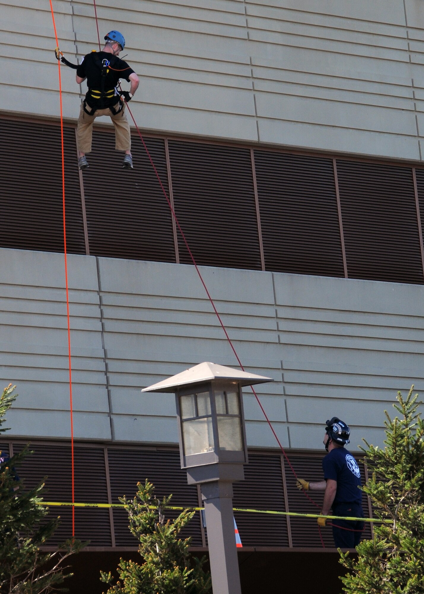 A Special Olympics volunteer assists Staff Sergeant Mike Lay as he completes his 19 story rappel at the "Over the Edge" event sponsored by Special Olympics at the Four Seasons Hotel, Saint Louis, Oct 7.  Lay, an avid skydiver, was exhilarated by the experience and ready to go a second time. The Missouri Air and Army National Guard is an official sponsor of Special Olympics.  Lay  is a members of the Security Forces of the 131st Bomb Wing, Missouri Air National Guard, at Lambert-Saint Louis,  (Photo by Master Sgt. Mary-Dale Amison).  
