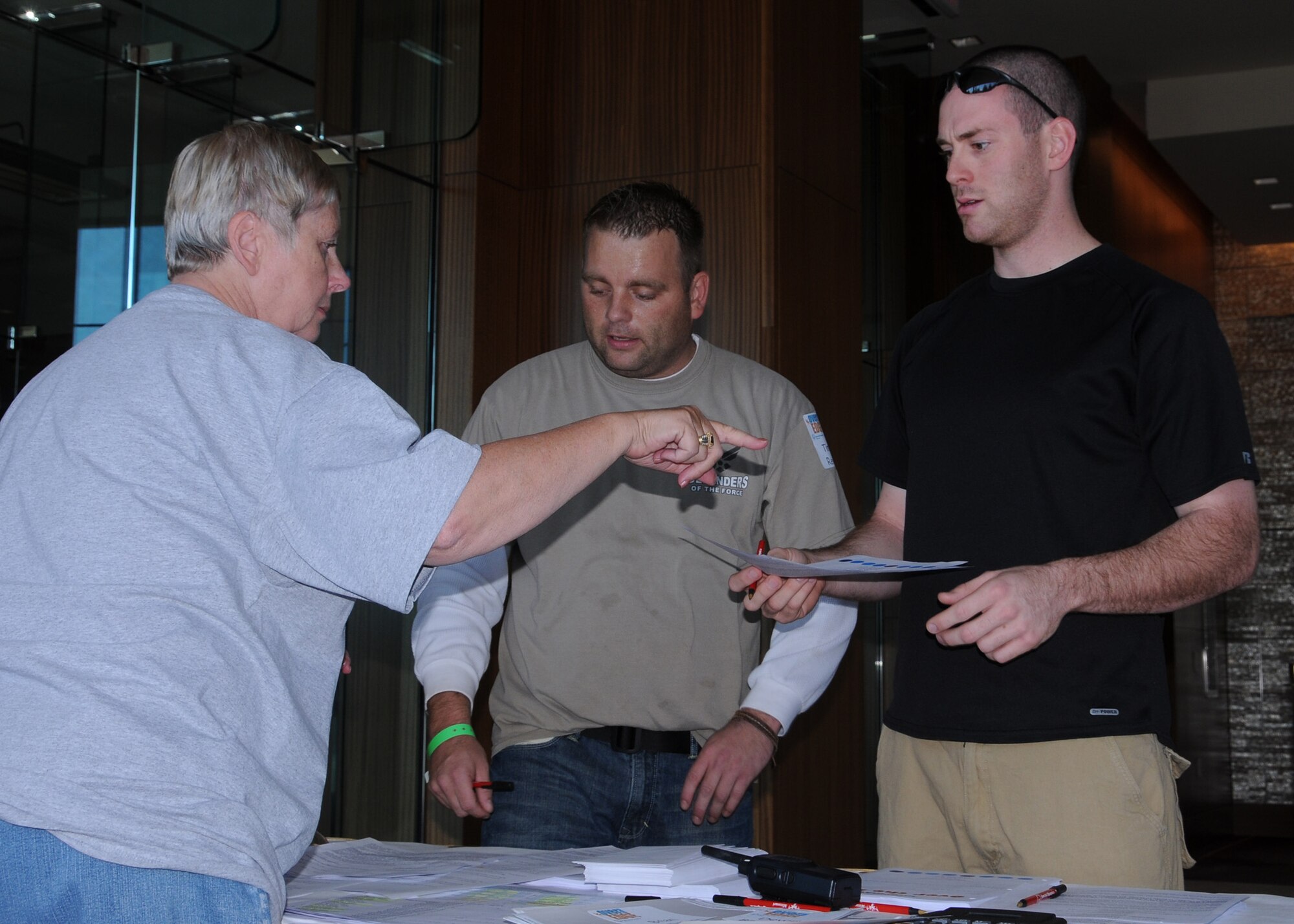 Staff Sgts. Tim Reynolds (l) and Mike Lay receive instructions from a volunteer during registration for the "Over the Edge" rappelling fundraiser for Special Olympics at the Four Seasons Hotel-Saint Louis, Oct 7.  Both raised  over $1000.00 in support of Special Olympics in the Saint Louis area.  This donation allows both entry into the "Over the Edge" event where participants rappel down the 19-story Four Seasons Hotel.  The Missouri Air and Army National Guard is an official sponsor of Special Olympics.  Reynolds and Lay are members of the Security Forces of the 131st Bomb Wing,  Missouri Air National Guard, at Lambert-Saint Louis,  (Photo by Master Sgt.
Mary-Dale Amison).  
