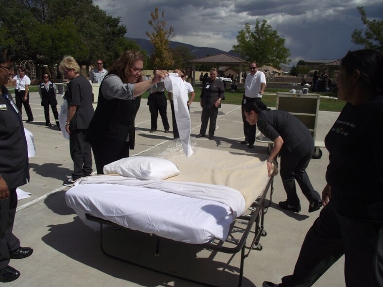 KIRTLAND AFB, N.M. -- Marisol Ortiz, left, and Susana Clonts, right, compete Sept. 29 at the Kirtland Inn Housekeeper Olympics at Millennium Park. (Photo by Stefan Bocchino) 