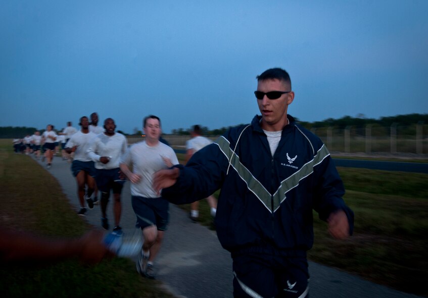 U.S. Air Force Airman 1st Class Kyle Dadswell, 23rd Logistics Readiness Squadron fuels distribution operator, reaches for a bottle of water during a 5K run in recognition of October’s national awareness observances at Moody Air Force Base, Ga., Oct. 7, 2011. Airmen from various agencies around base came together to participate in the event. After the run, participants were able to receive information on the awareness events during an information fair. (U.S. Air photo by Airman 1st Class Joshua Green/Released)               

