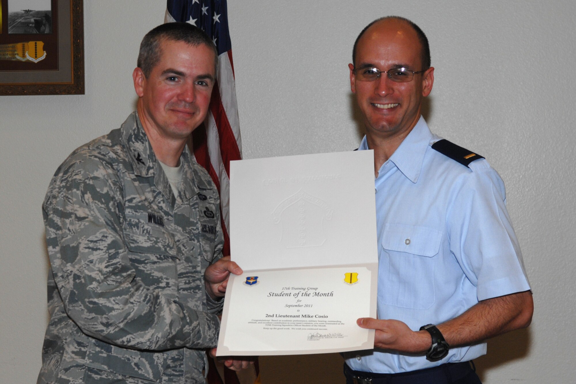 GOODFELLOW AIR FORCE BASE, Texas -- Col. JD Willis, 17th Training Group Commander, presents 2nd Lt. Mike Cosio with the 315th Training Squadron Officer Student of the Month award for September, Oct. 7. (U.S. Air Force photo/Staff Sgt. Laura R. McFarlane)