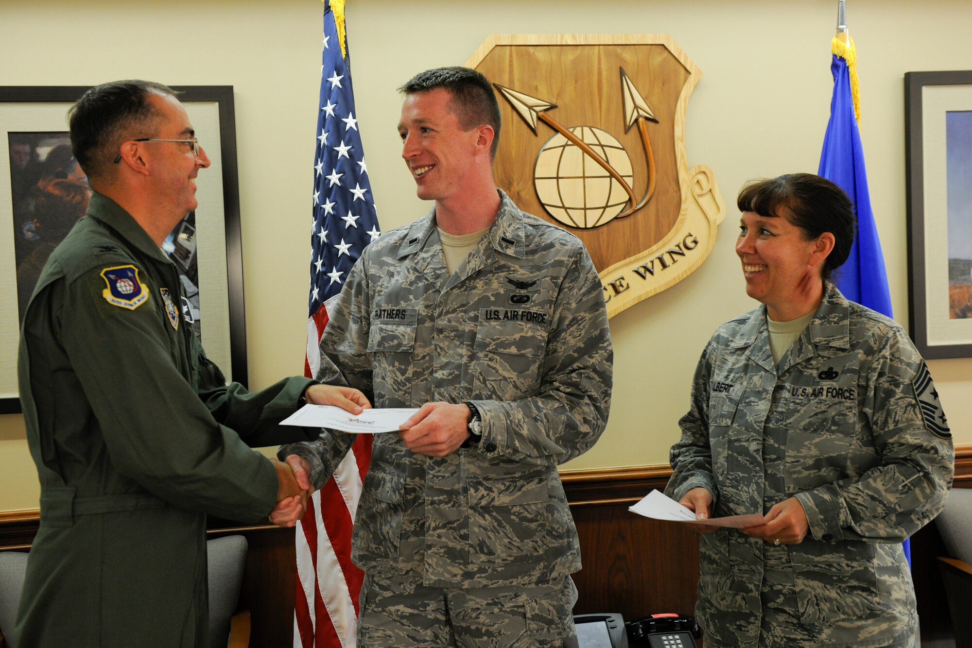 VANDENBERG AIR FORCE BASE, Calif. -- Col. Keith Balts, 30th Space Wing vice commander, hands his Combined Federal Campaign contribution to 1st Lt. George Flathers, Vandenberg's installation project officer, here Friday, October 7, 2011. Vandenberg set their goal to raise $185,000 for the CFC, which is a combination of thousands of local, national and international charities. (U.S. Air Force/Staff Sgt. Levi Riendeau)