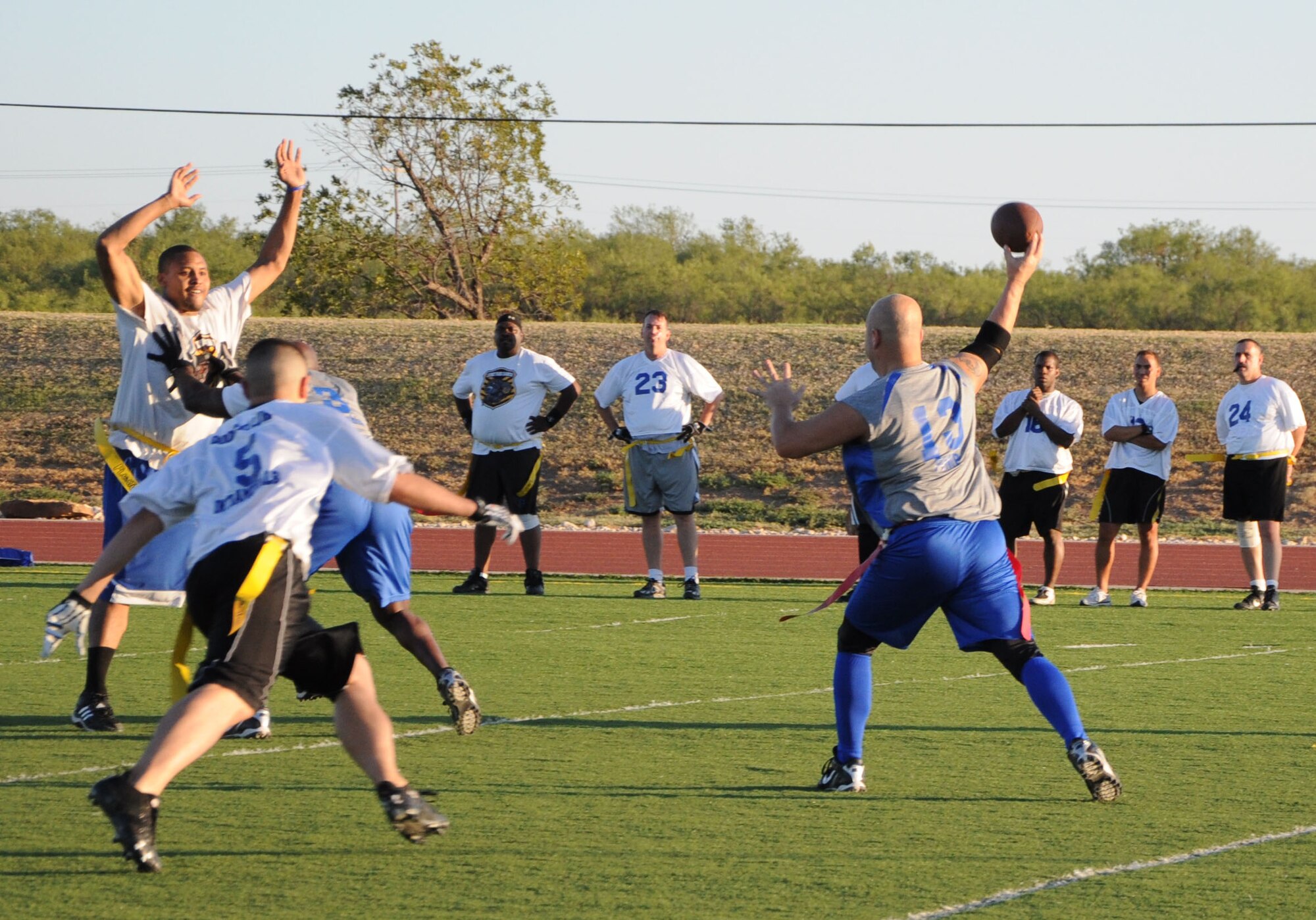 GOODFELLOW AIR FORCE BASE, Texas--  A member of the Mission Support Group’s flag football team, the Junkyard Dawgs attempts to block a pass by the 316th Training Squadron Sharks’ quarterback Oct. 6 at Mathis Field. The Junkyard Dawgs beat the Sharks 19:0, taking home the season’s championship. (U.S. Air Force photo/Airman 1st Class Jessica Keith)