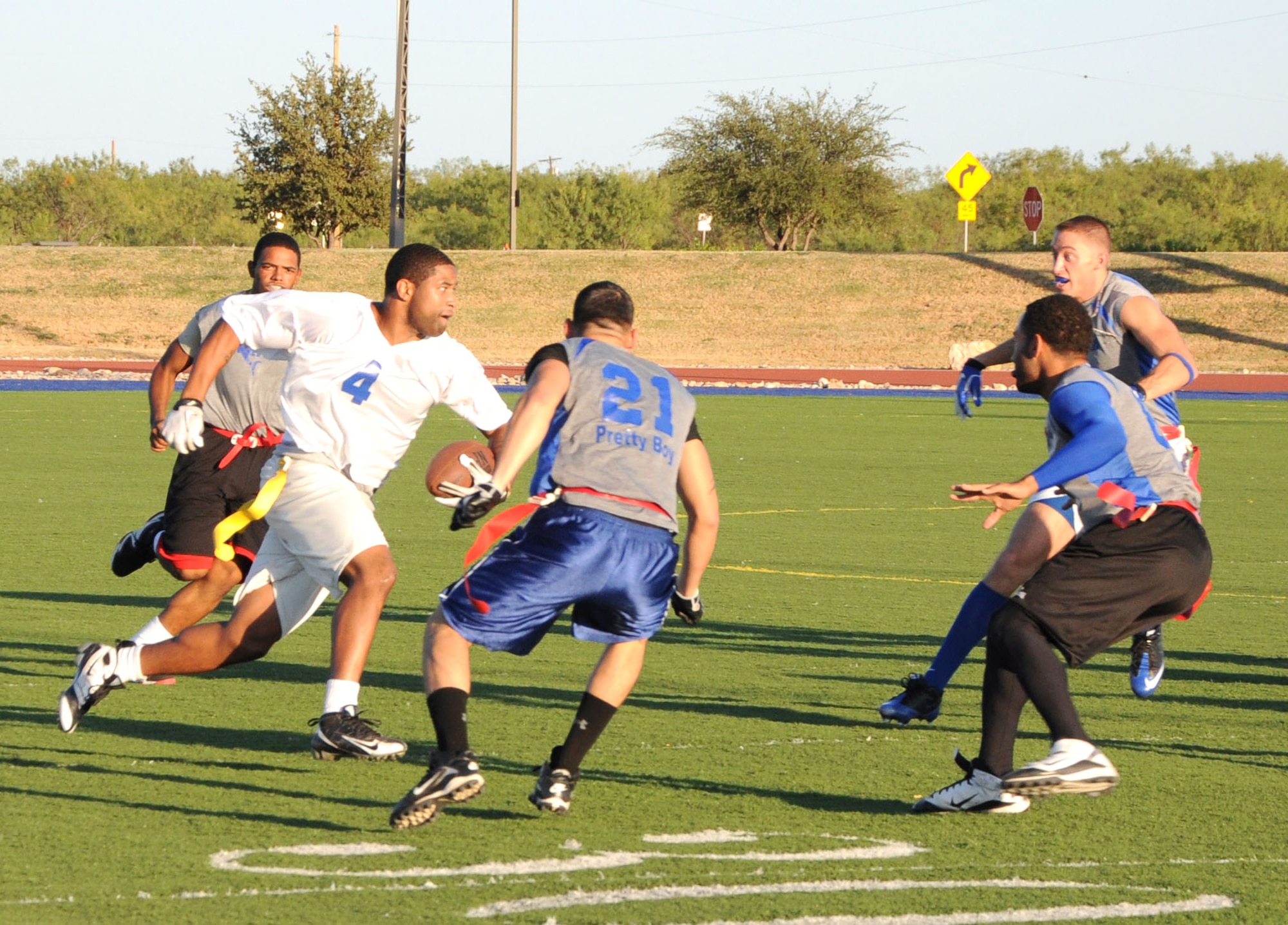 GOODFELLOW AIR FORCE BASE, Texas--  A member of the Mission Support Group’s flag football team, the Junkyard Dawgs, Clifton Gathers, 17th Comptroller Squadron, attempts to break through the opposing teams defenses, Oct. 6 at Mathis Field. The Junkyard Dawgs beat the Sharks 19:0, taking home the season’s championship. (U.S. Air Force photo/Airman 1st Class Jessica Keith)