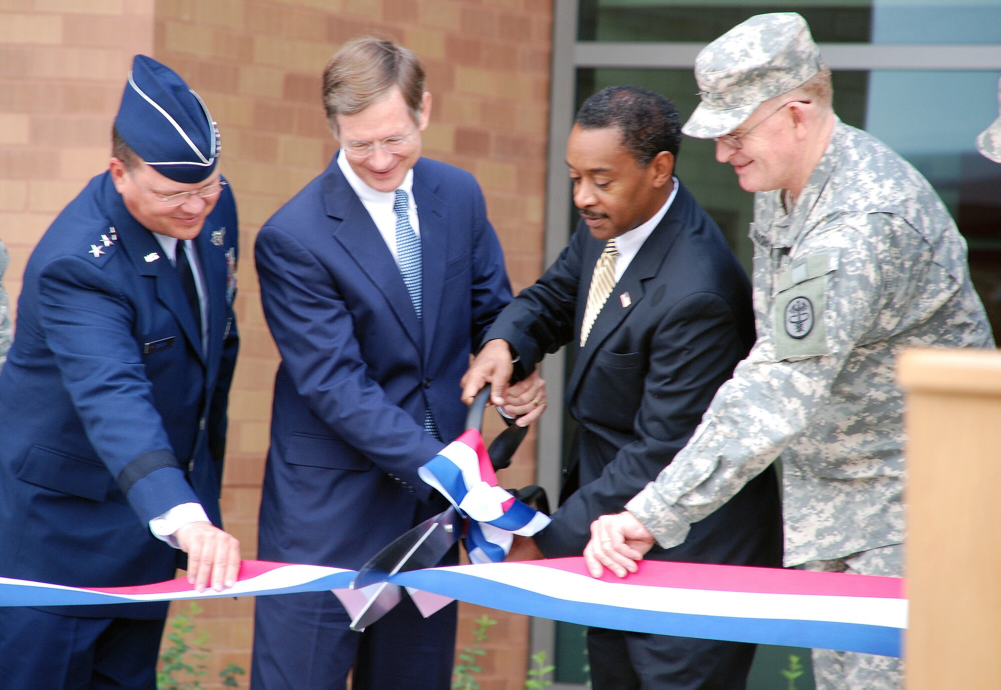 Lt. Gen. Charles B. Green, surgeon general of the Air Force, U.S. Rep. Lamar Smith, Dr. Jonathan Woodson, assistant secretary of Defense for Health Affairs and director of TRICARE Management Activity, and Lt. Gen. Eric B. Schoomaker, surgeon general of the Army (left to right), cut the ribbon to open the new Consolidated Tower Oct. 7,2011 at the San Antonio Military Medical Center, Fort Sam Houston, Texas. The new 760,000-square-foot tower will provide a seven-story inpatient bed tower, four-story ancillary care center, and three-story outpatient clinical and administrative space. (U.S. Army photo by Maria Gallegos)