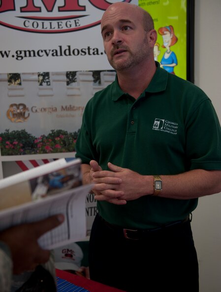 Ed Rains, Georgia Military College Moody program coordinator, talks to an Airman about furthering their schooling during an education fair Oct. 5, 2011, at Moody Air Force Base, Ga. Rains was one of many individuals present at the Base Exchange who provided information to members on their education options. (U.S. Air Force photo Airman 1st Class Nicholas Benroth/Released)