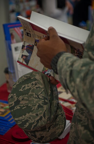 A U.S. Air Force military member reads through an educational booklet on course information during an education fair Oct. 5, 2011, at Moody Air Force Base, Ga. The fair was held to spread knowledge on the different programs available at the education center for Moody members to take part in. (U.S. Air Force photo Airman 1st Class Nicholas Benroth/Released)
