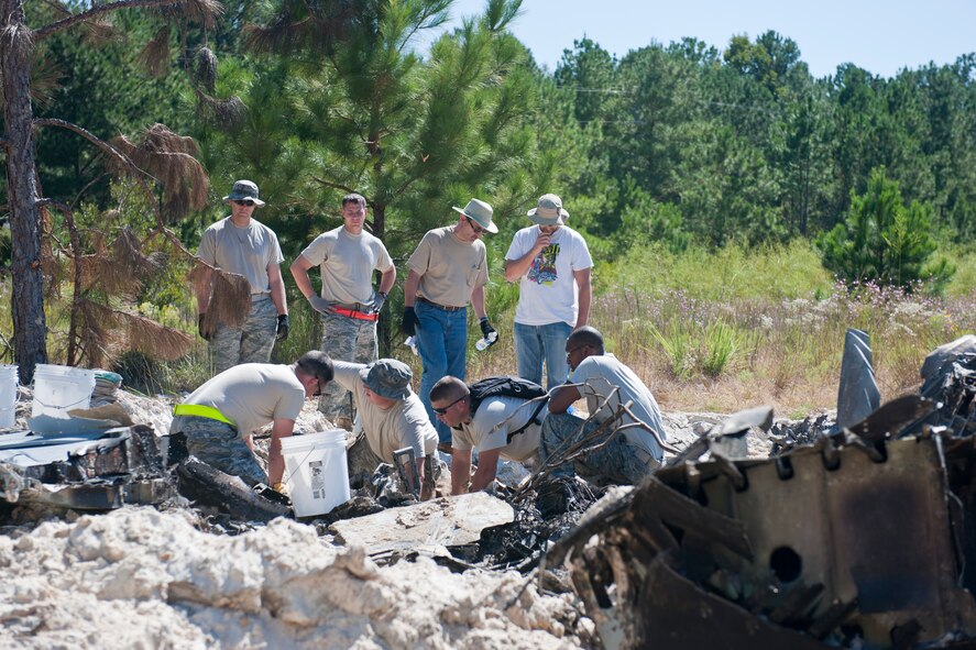 Members of an investigation board collect and recover remains of a crashed A-10C Thunderbolt II aircraft Oct. 4, 2011, in a non-residential area northeast of Berlin, Ga., in Cook County. Since the early stages of the investigation, the board has focused their efforts to analyze evidence and data to determine the cause of the crash that occurred Monday, Sept. 26, 2011. Upon completion, Air Combat Command will release investigation results. (U.S. Air Force photo by Staff Sgt. Jamal D. Sutter/Released) 