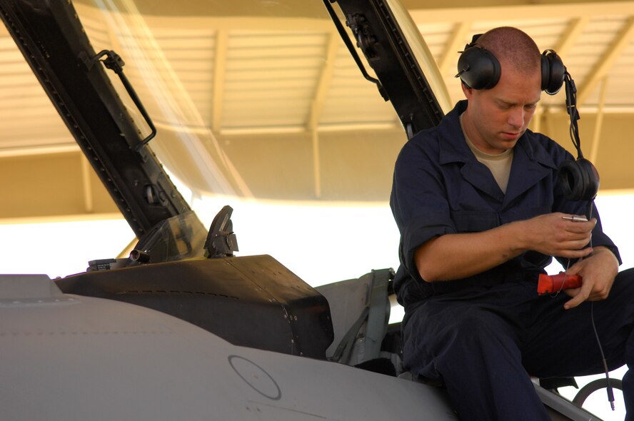 U.S. Air Force Senior Airman Nathen Hansen, 20th Aircraft Maintenance Squadron crew chief, prepares an F-16 Fighting Falcon to be launched, Shaw Air Force Base, S.C. Oct. 5, 2011. The F-16s have been part of the Air Force arsenal for more than 36 years and are a vital part of the  Air Force mission.  (U.S. Air Force photo by Airman 1st Class Ashley L. Gardner/ Released)