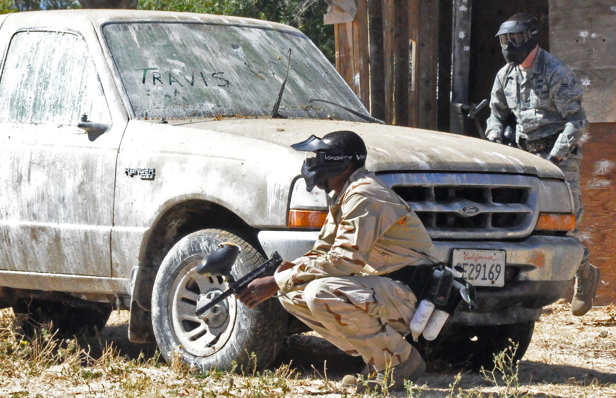 Members of the 60th Civil Engineer  Squadron charlie flight use tactical movements, man made and natural cover and team communication to maneuver their way through cities and capture the flags at the paintball range on Travis, Sept. 27. at the paintball range on Travis. The paintball range was the first event of a weeklong competition within the 60th CES developed to test wartime skills capabilities of members in the squadron. (U.S. Air Force photo/ Airman Madelyn Ottem)