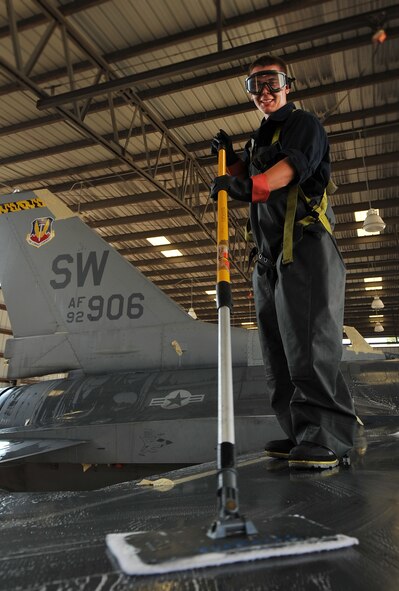 U.S. Air Force Airman 1st Class Andy Harcz, 79th Fighter Squadron crew chief, scrubs the wing of an F-16 Fighting Falcon, Sept. 14, 2011, Shaw Air Force Base, S.C. The F-16 crew chiefs try to ensure their jets are thoroughly washed every 180 days to prevent dirt buildup and corrosion. (U.S. Air Force photo by Senior Airman Kenny Holston/Released)