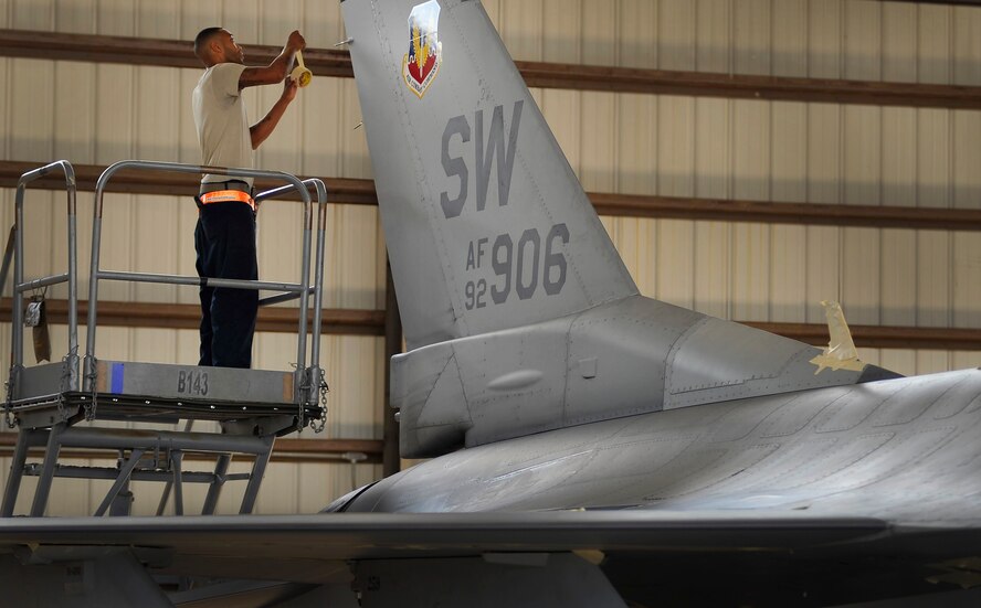 U.S. Air Force Senior Airman E. J. Thompson, 79th Fighter Squadron crew chief, tapes up electrical ports on an F-16 Fighting Falcon in preparation for the jet to be washed, Sept. 14, 2011, Shaw Air Force Base, S.C. The F-16 crew chiefs try to ensure their jets are thoroughly washed every 180 days to prevent dirt buildup and corrosion. (U.S. Air Force photo by Senior Airman Kenny Holston/Released)