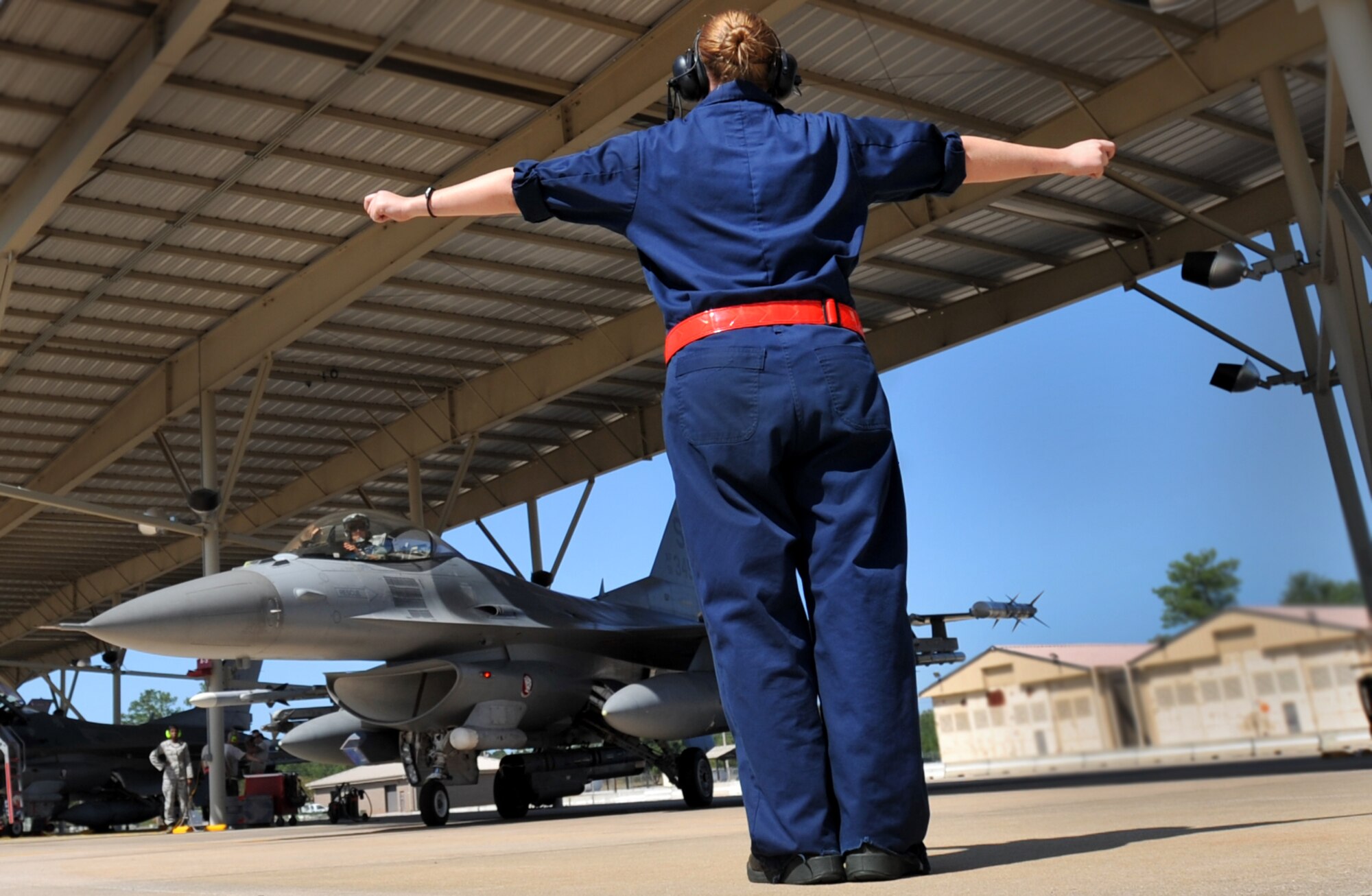 U.S. Air Force Airman 1st Class Erica Sanicky, 77th Fighter Squadron crew chief, launches an F-16 Fighting Falcon, Oct. 5, 2011, Shaw Air Force Base, S.C. Sanicky and other 77th crew chiefs launched several F-16s to help pilots prepare for real world missions. (U.S. Air Force photo by Senior Airman Kenny Holston/Released)



