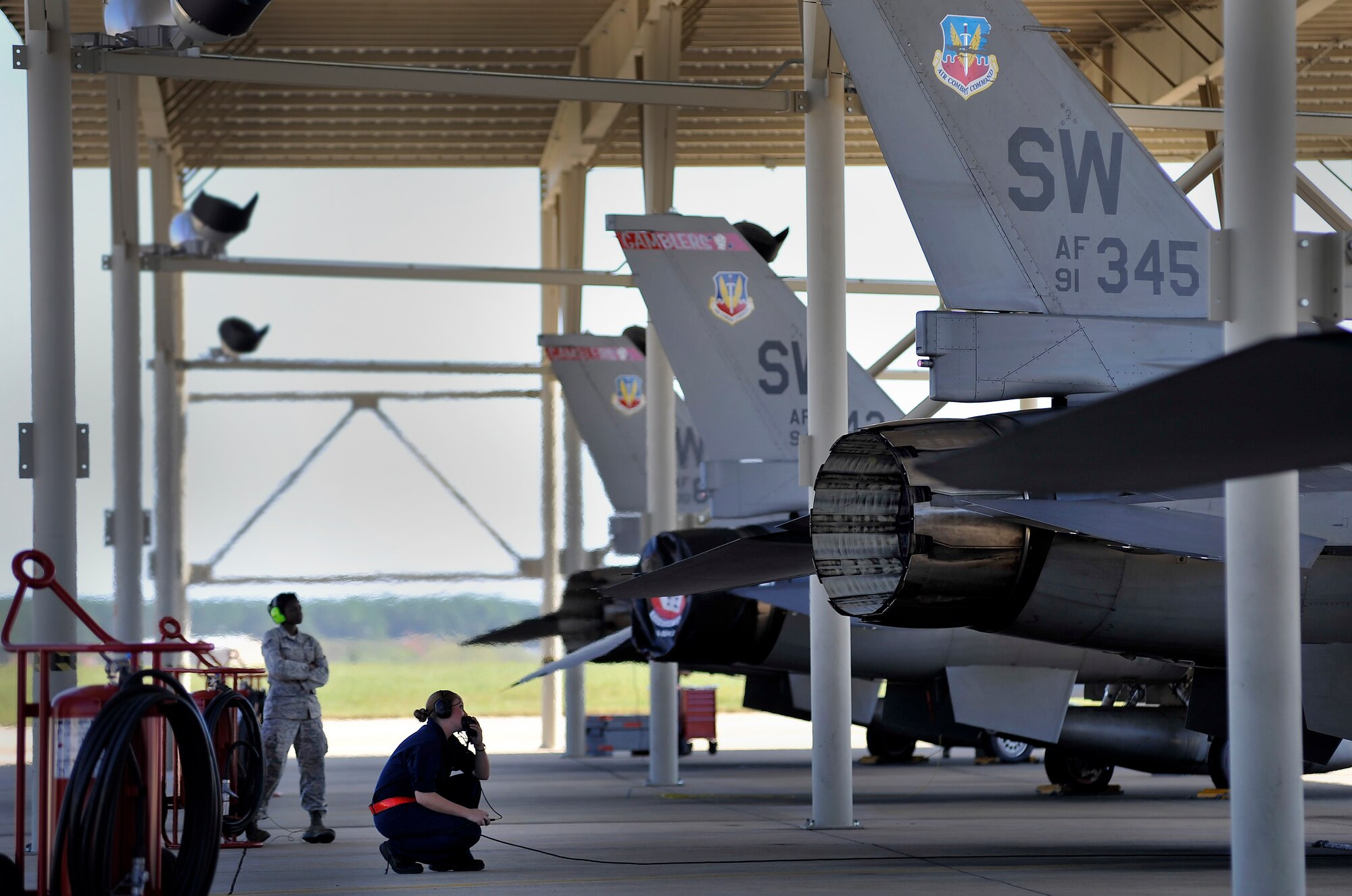 U.S. Air Force Airman 1st Class Erica Sanicky, 77th Fighter Squadron crew chief,(left) completes her pre-flight checks prior to launching an F-16 Fighting Falcon, Oct. 5, 2011, Shaw Air Force Base, S.C. Sanicky and other 77th crew chiefs launched several F-16s to help pilots prepare for real world missions. (U.S. Air Force photo by Senior Airman Kenny Holston/Released)



