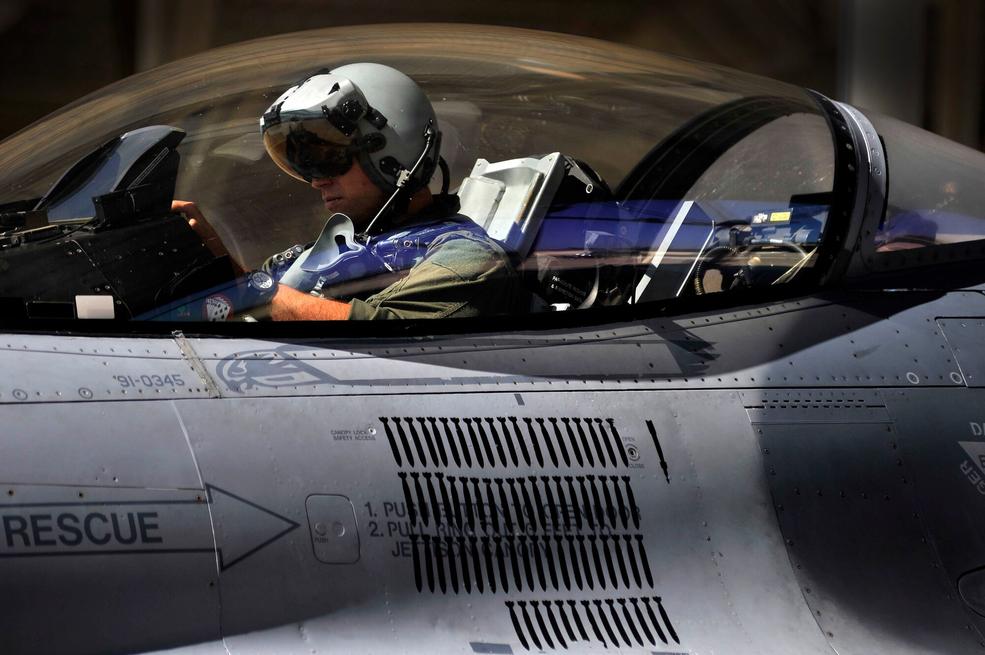 A U.S. Air Force F-16 Fighting Falcon pilot with the 77th Fighter Squadron adjusts in his cockpit before takeoff, Oct. 5, 2011, Shaw Air Force Base, S.C. Crew chiefs with the 77th FS launched several F-16s to help pilots prepare for real world missions. (U.S. Air Force photo by Senior Airman Kenny Holston/Released)


