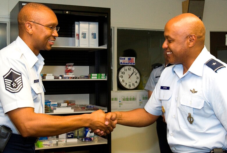PATRICK AIR FORCE BASE, Fla. -- Brig. Gen. Anthony Cotton, 45th Space Wing commander, awards a commander's coin to Master Sgt. Rodney Huffman, 45th Space Communications Squadron Superintendent, for his part in the resuce and treatment of a stabbing victim from a car sinking in the Indian River, just a few miles from the base. Master Sgt. Kenneth Swainston, a Reservist with the 920th Rescue Wing at Patrick,
Staff Sgt. Jesus  Pino, 45th Aerospace Medicine Squadron, and Huffman are all credited with helping a Brevard County Sheriff’s Deputy rescue and treat the woman Sept. 6, after the deputy had just shot a suspect who had been stabbing the woman in the passenger seat of the partially submerged car. (U.S. Air Force photo/Julie Dayringer)