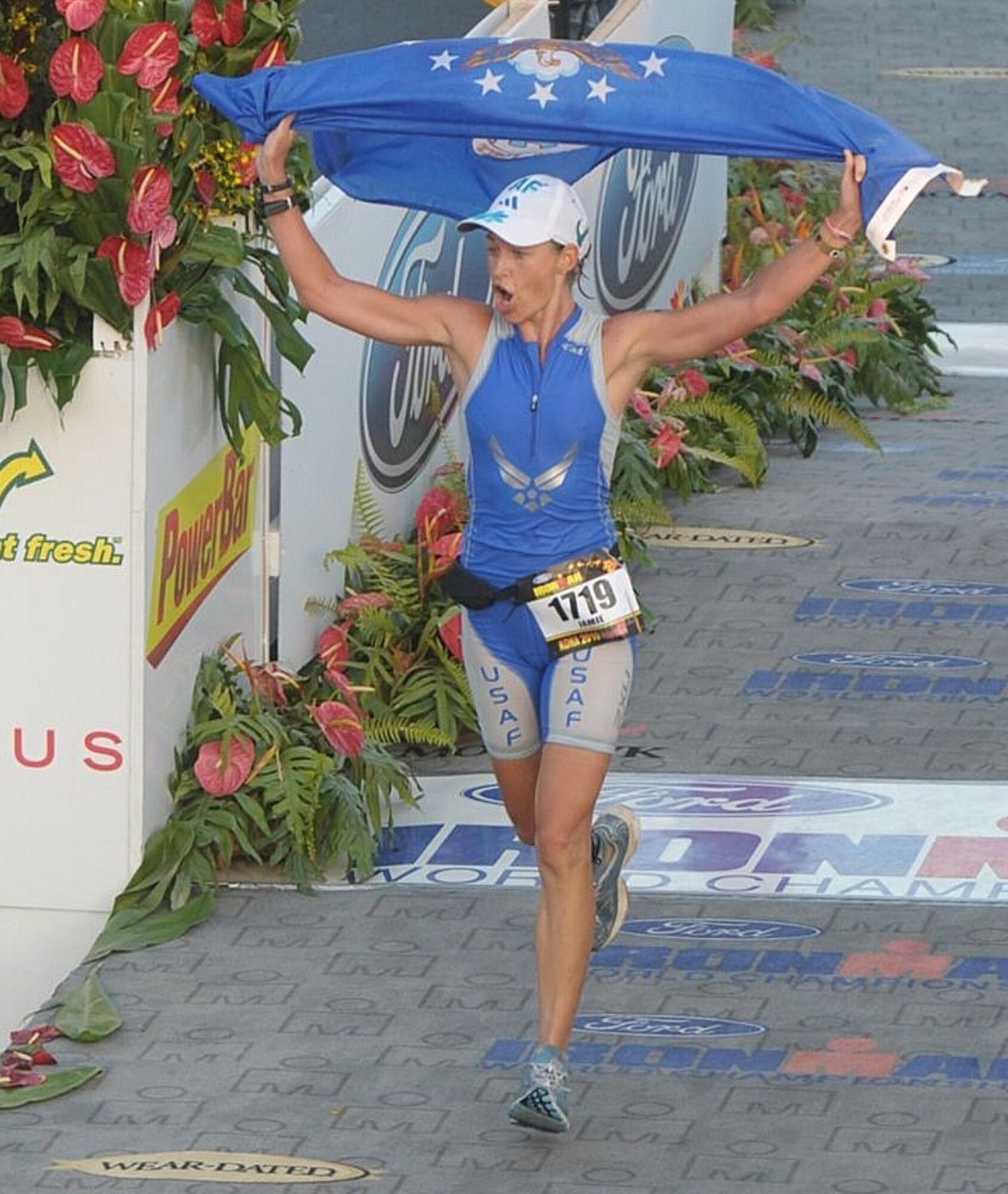 Capt. Jamie Turner crosses the finish line in 10:48:31 during the Ford Ironman World Championship Oct. 9, 2010 at Kona, Hawaii. During the race, Captain Turner endured a 2.4-mile swim, a 112-mile bike ride and a 26.2-mile marathon. Captain Turner is a pilot with the 315th Airlift Wing. (U.S. Air Force courtesy photo from the 2010 Ford Ironman World Championship /Action Sports International)