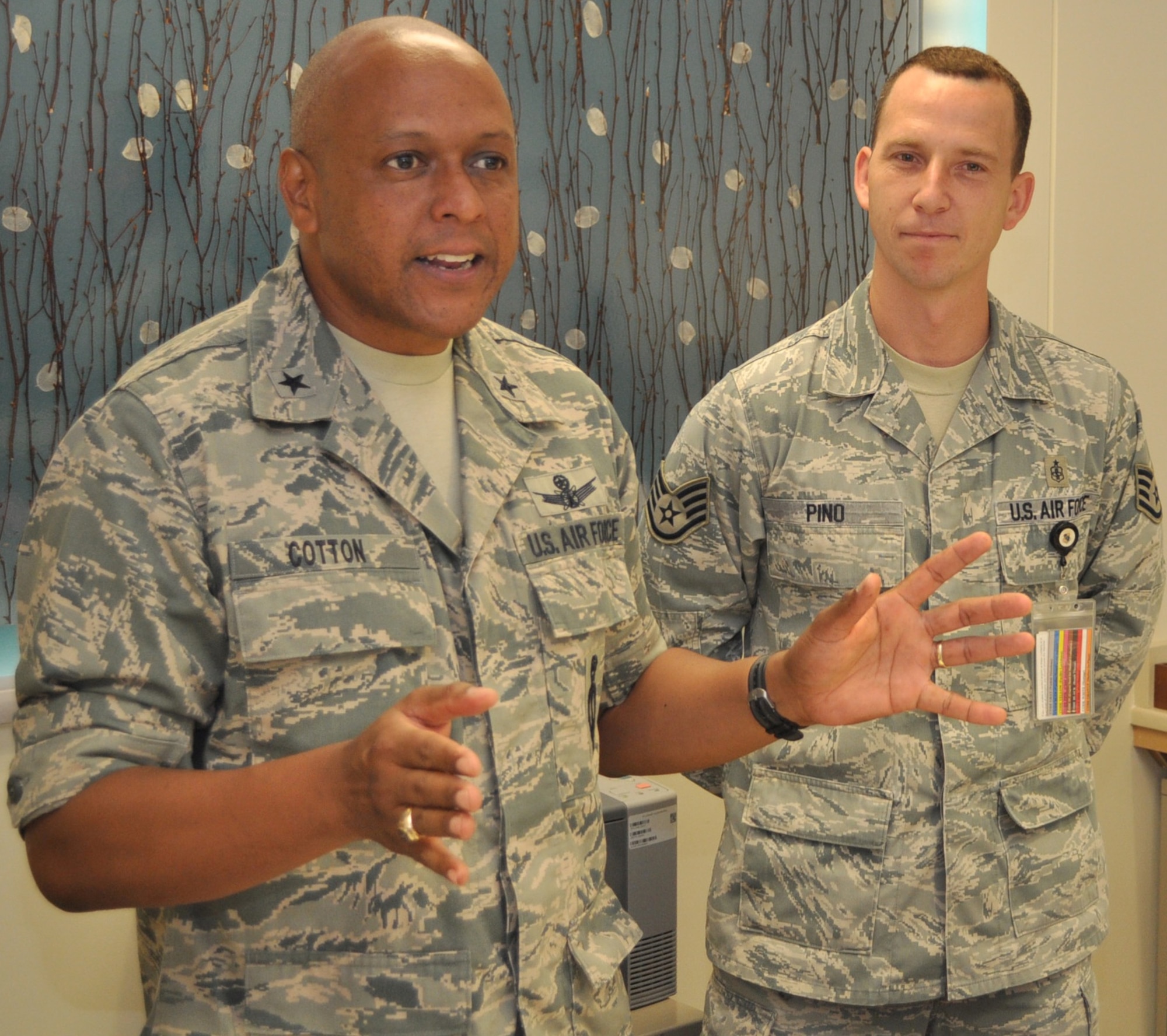 Brig. Gen. Anthony Cotton, 45th Space Wing commander, congratulates Staff Sgt. Jesus Pino, 45th Aerospace Medicine Squadron, Sept. 8, after awarding him a commander’s coin for his part in the rescue and treatment of a stabbing victim from a car sinking in the Indian River, just a few miles from Patrick AFB. Master Sgt. Rodney Huffman, 45th Space Communications Squadron Superintendent, Master Sgt. Kenneth Swainston, a Reservist with the 920th Rescue Wing at Patrick, and Pino are all credited with helping a Brevard County Sheriff’s Deputy rescue and treat the woman Sept. 6, after the deputy had just shot a suspect who had been stabbing the woman in the passenger seat of the partially submerged car. (U.S. Air Force photo/Jack Trimboli)