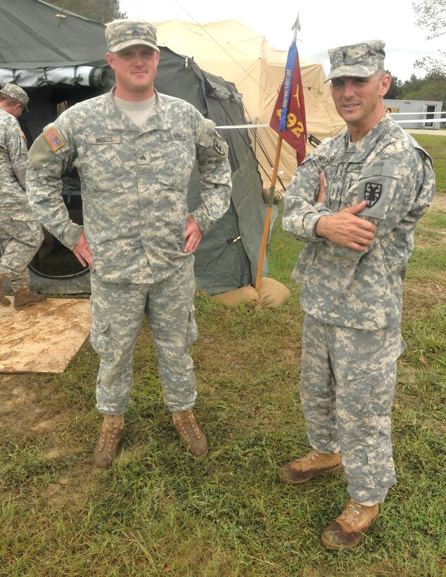 Sgt. Greg Ingalls (left), operations NCO, 492nd Transportation Company (Harbormaster), 24th Transportation Battalion, 7th Sustainment Brigade, stands outside the Harbormaster Command and Control Center with Chief Warrant Officer Danny McCabe, company commander, at Fort Eustis’ Anzio Beach located on the James River during the battalion’s field testing of the HCCC equipment upgrade, the morning of Sept. 25. (U.S. Army photo by Sgt. 1st Class Kelly Jo Bridgwater/Released)