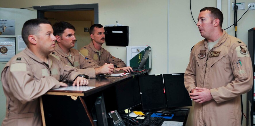 A B-1B Lancer flight crew receives a pre-flight briefing, Oct. 7, 2011, at an undisclosed location in Southwest Asia, prior to a mission marking the 10th anniversary since the airframe's first involvement in combat operations in support of Operation Enduring Freedom.  In late September 2001, B-1Bs or "Bones" from the 34th and 37th Bomb Squadrons deployed to Diego Garcia from Ellsworth Air Force Base, S.D. Shortly thereafter, the two squadrons merged to become the 34th Expeditionary Bomb Squadron. The 34th EBS is currently assigned to the 379th Air Expeditionary Wing. (U.S. Air Force photo/Senior Airman Paul Labbe)
