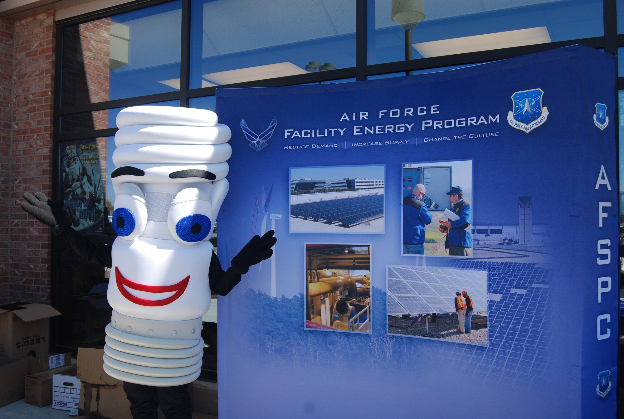 PETERSON AIR FORCE BASE, Colo. -- PeteLight, the Peterson energy awareness mascot, stands outside the Peterson Base Exchange Oct. 5, 2011, as part of Energy Awareness Month. The 21st Civil Engineer Squadron’s environmental team was there to promote this year’s theme: Think Green, Build Green, Fly Blue. They provided information about energy conservation and handed out CFLs and reusable shopping bags. There are currently energy saving projects underway in 18 buildings on Peterson. Projects include repairs to heating, ventilation and air conditioning systems to increase efficiency and upgrading lighting. Since 2003, the Air Force has cut its energy usage by 15 percent. (U.S. Air Force photo/Lea Johnson)