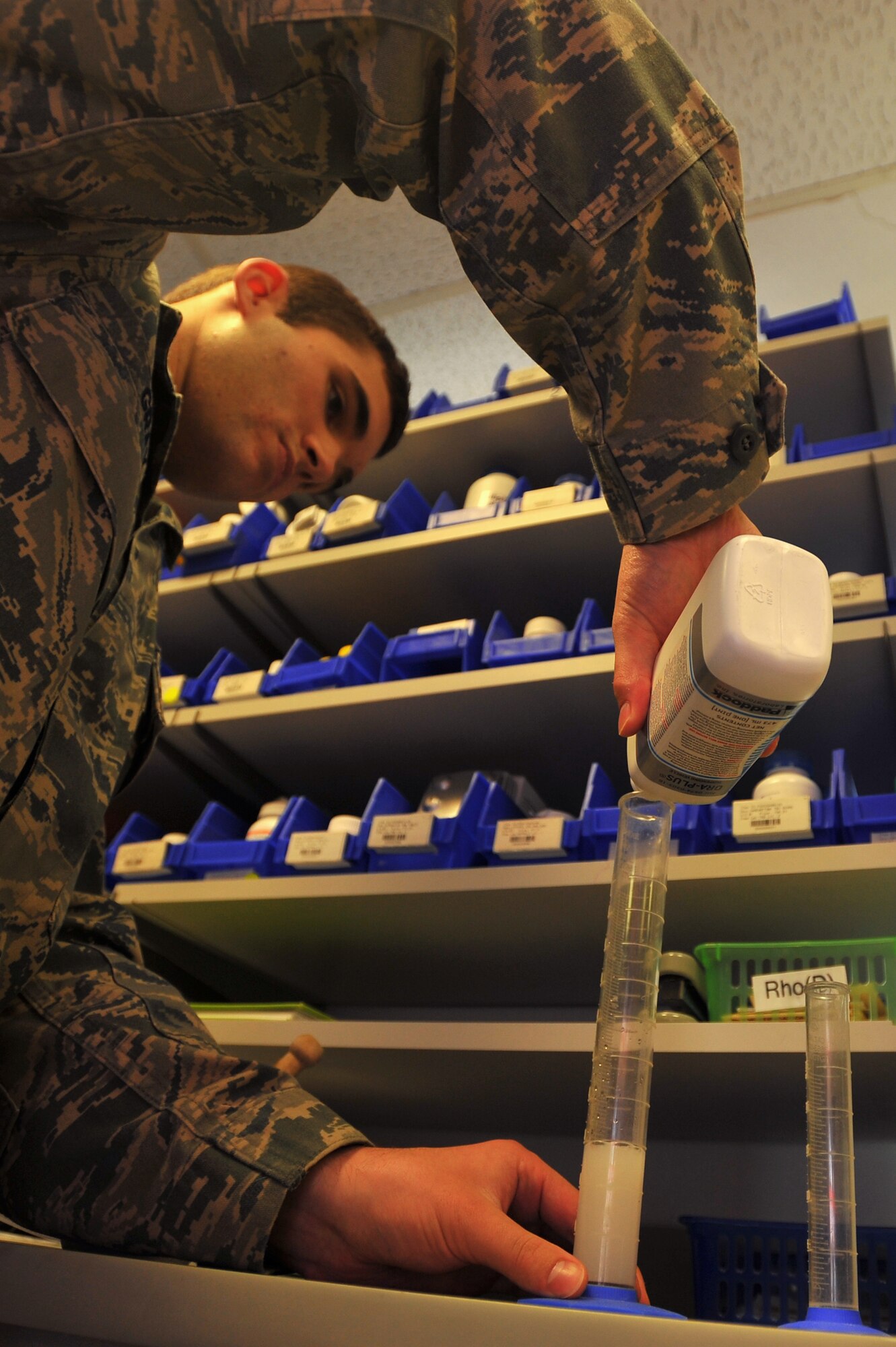 SPANGDAHLEM AIR BASE, Germany – Airman Ian Gray, 52nd Medical Support Squadron pharmacy technician, pours glycerin into a graduated cylinder while filling a prescription inside the 52nd Medical Group Pharmacy here Oct. 5. On average, the pharmacy fills approximately 200 prescriptions each day. The pharmacy serves a vital role in promoting Airmen and family health and wellness. (U.S Air Force photo/Airman 1st Class Dillon Davis)