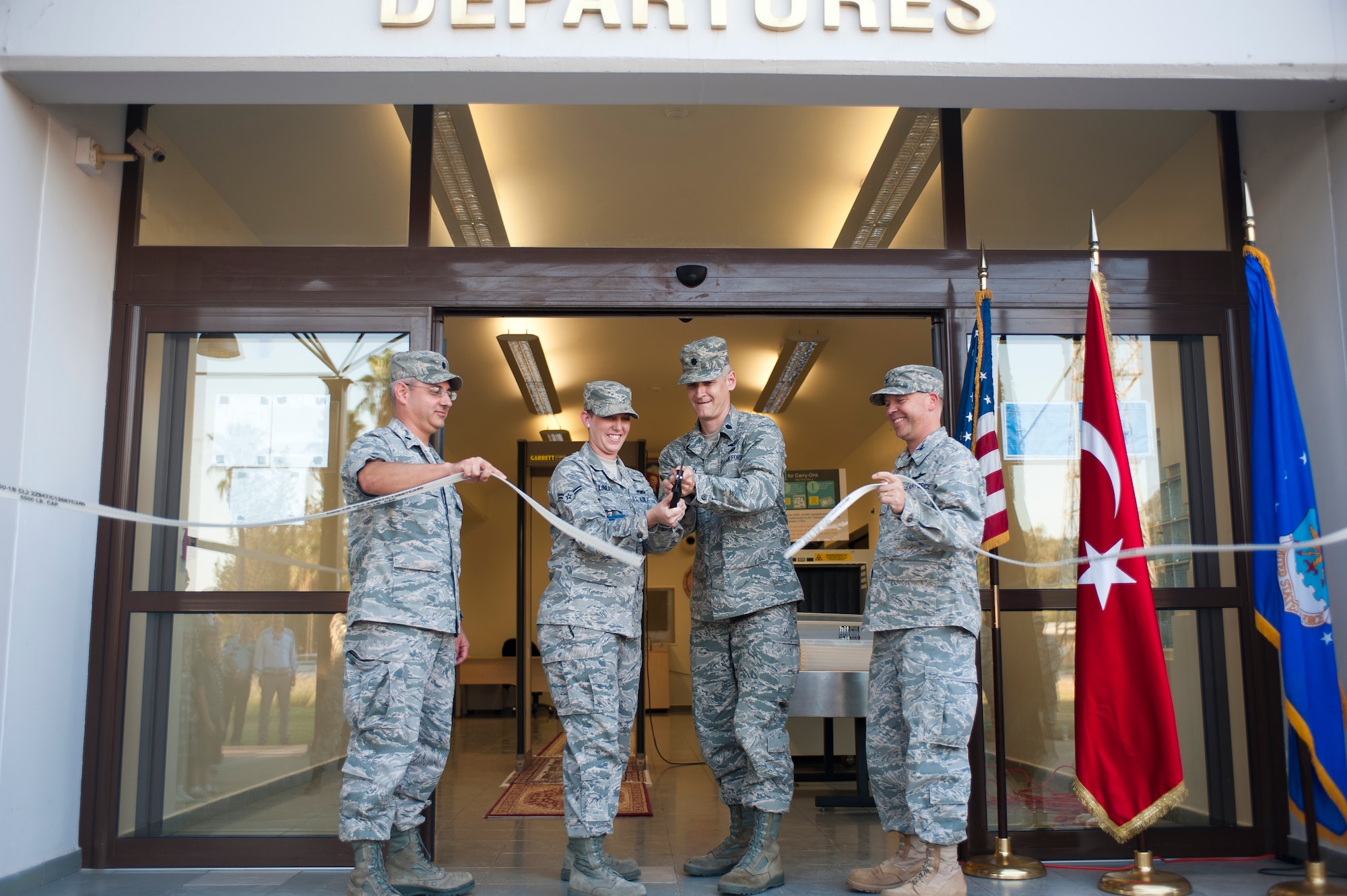 From left to right, Lt. Col. Ken Timko, 521st Air Mobility Operations Group deputy commander; Airman 1st Class Elizabeth Linley, 728th Air Mobility Squadron; Lt. Col. Brian Lindsey, 728th AMS commander; and Col. Chad Butts, 39th Air Base Wing vice commander, cut the ribbon during the Air Mobility Command Passenger Terminal reopening Oct. 5, 2011, at Incirlik Air Base, Turkey. The improvements to the terminal include a new heating, ventilation and air conditioning system; a drop ceiling; improved lighting to increase interior luminosity; and updates to the family and special category lounges. The terminal was constructed in 1972, an automated conveyor belt was added in 1997 and an arrival terminal in 2004. (U.S. Air Force photo by Senior Airman Clayton Lenhardt/Released)