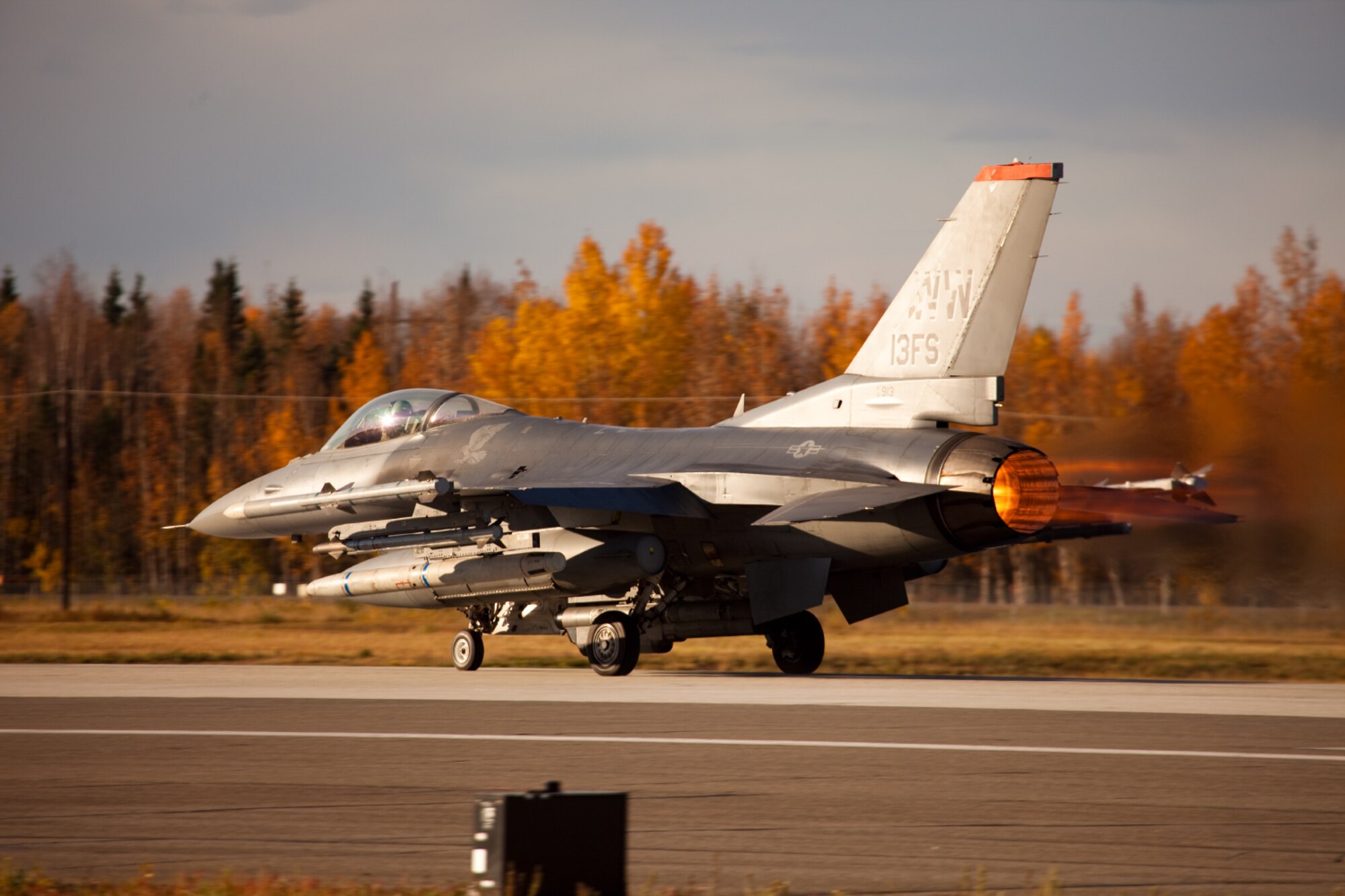 An F-16 Fighting Falcon from the 13th Fighter Squadron at Misawa Air Base, Japan takes off from the flightline at Eielson Air Force base, Alaska Sept. 20.Several units from Misawa are participating in the Distant Frontier exercise. The exercise hones pilot’s air-to-ground and air-to-air skills by simulating realistic enemy surface-to-air missile fire and advanced enemy air combat tactics. (Courtesy photo)