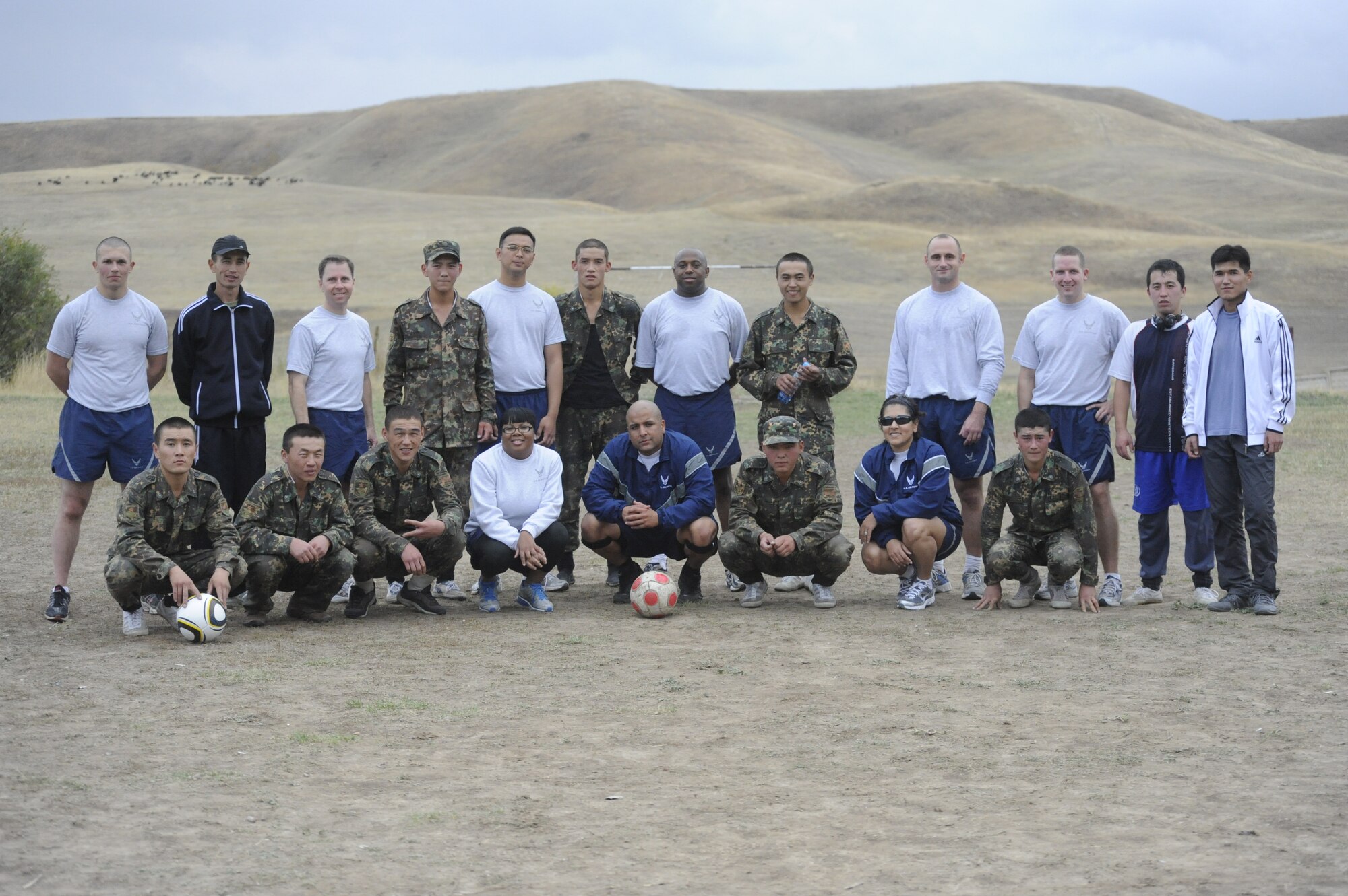 Airmen from the Transit Center at Manas and soldiers from the Koi Tash Noncommissioned Officers Academy, Kyrgyzstan, pose for a photo after spending the day practicing language skills and playing sports Oct. 6. Airmen from the Transit Center travel to the academy twice a month to participate in an English and Russian language lab. Occasionally the service members play sports after completing their language studies. The partnership program was established in June.  (U.S. Air Force photo/Tech. Sgt. Tammie Moore)
