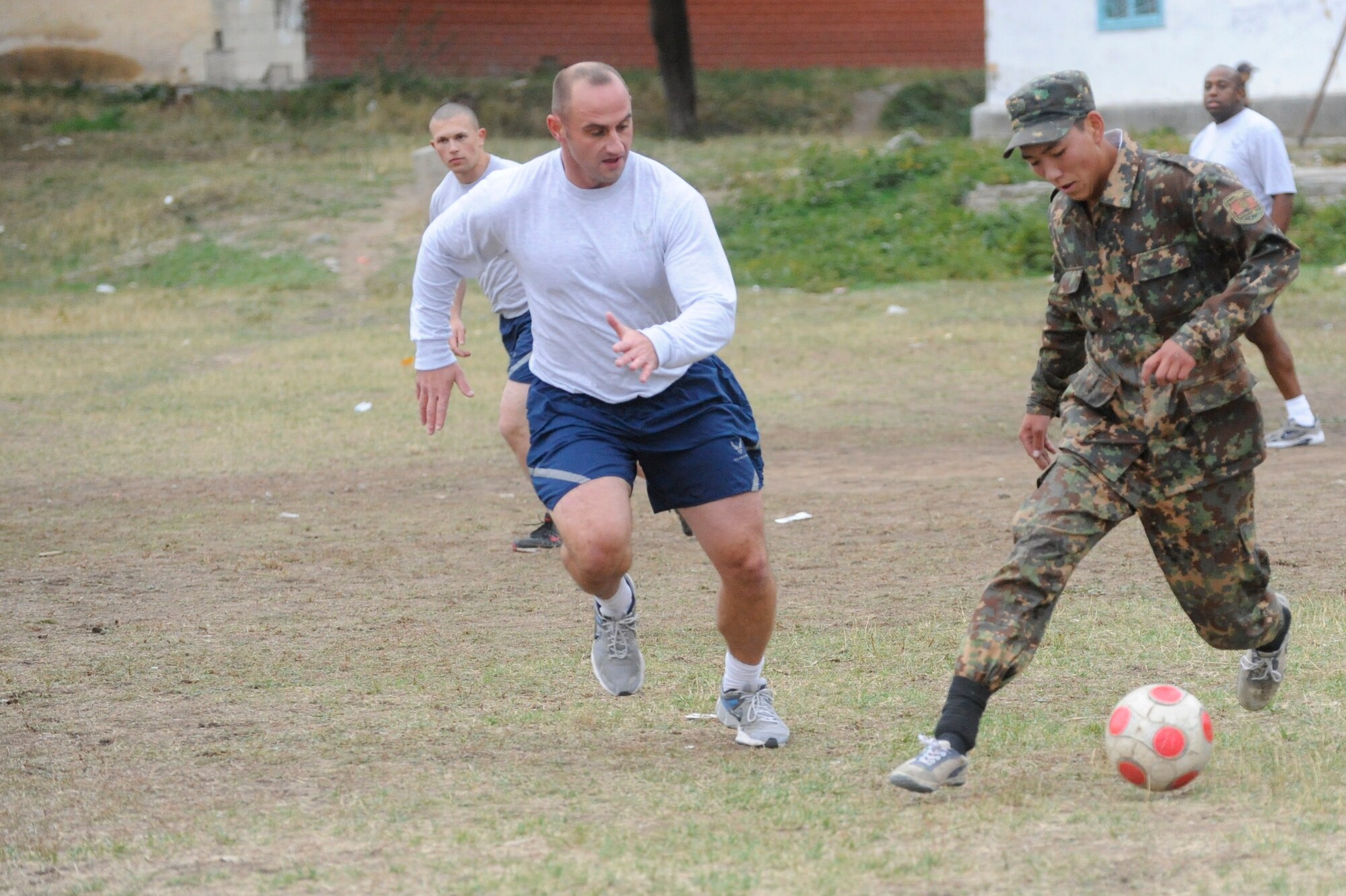 Master Sgt. Sam Nelson and other Airmen play soccer with Kyrgyz Republic soldiers at the Koi Tash Noncommissioned Officers Academy, Kyrgyzstan, after participating in a language lab Oct. 6. Nelson is assigned to the Theater Security Cooperation as the NCO-in-charge of humanitarian assistance. He is deployed to the Transit Center at Manas from Bellows Air Force Station, Hawaii. (U.S. Air Force photo/Tech. Sgt. Tammie Moore)