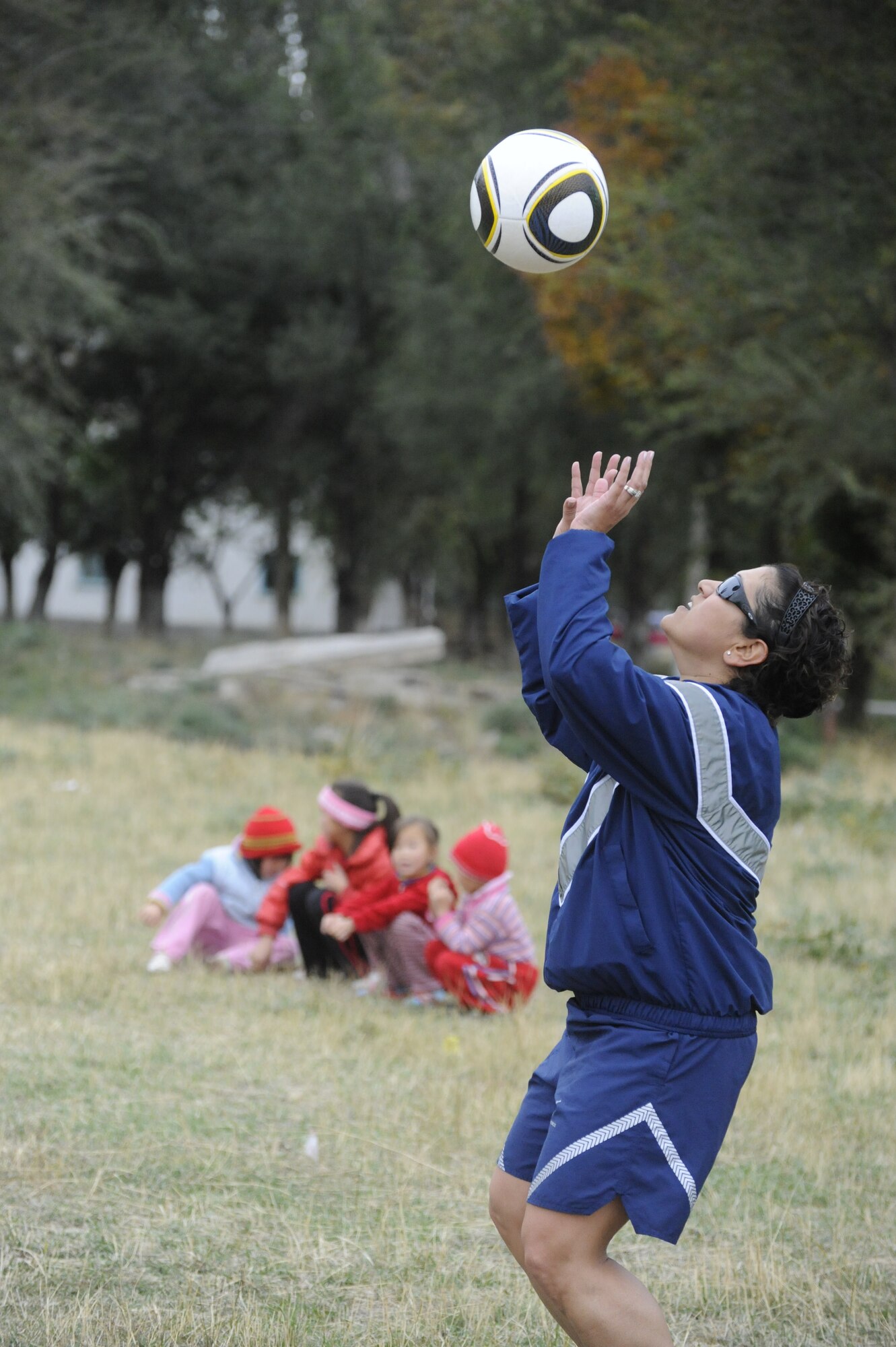 Master Sgt. Leenette Joseph prepares to set the ball as she plays volleyball with soldiers and children at the Koi Tash Noncommissioned Officers Academy, Kyrgyzstan, after participating in a language lab Oct. 6. Joseph is assigned to the 376th Air Expeditionary Wing Equal Opportunity Office as the director. She is deployed to the Transit Center at Manas from Barksdale Air Force Base, La. (U.S. Air Force photo/Tech. Sgt. Tammie Moore)