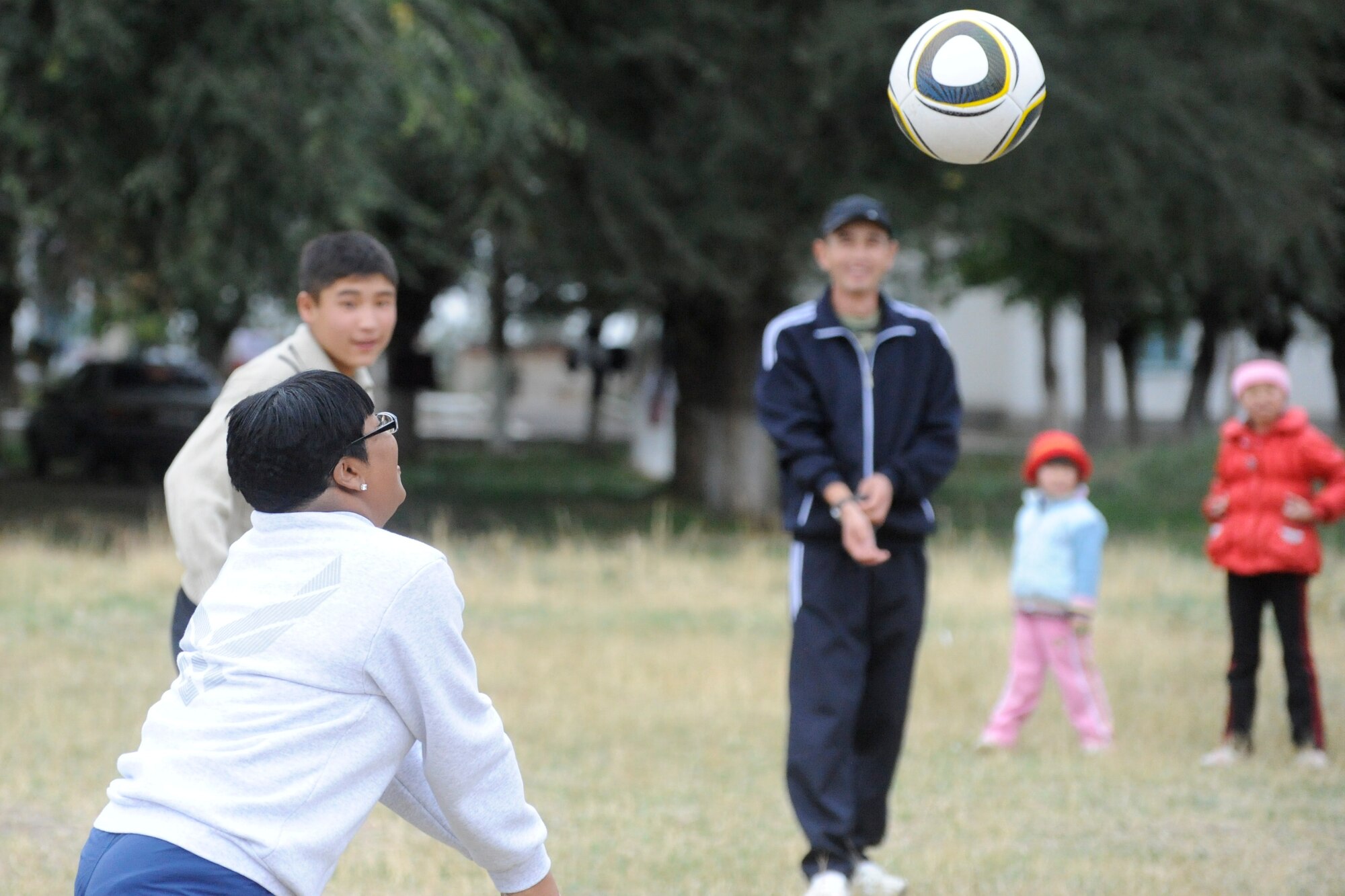 Senior Master Sgt. Colleen Blake-Harris plays volleyball with soldiers and children at the Koi Tash Noncommissioned Officers Academy, Kyrgyzstan, after participating in a language lab Oct. 6. Blake-Harris is assigned to the 376th Air Expeditionary Wing Legal Office as the superintendent and the wing staff agency superintendent. She is deployed to the Transit Center at Manas from Nellis Air Force Base, Nev. (U.S. Air Force photo/Tech. Sgt. Tammie Moore)